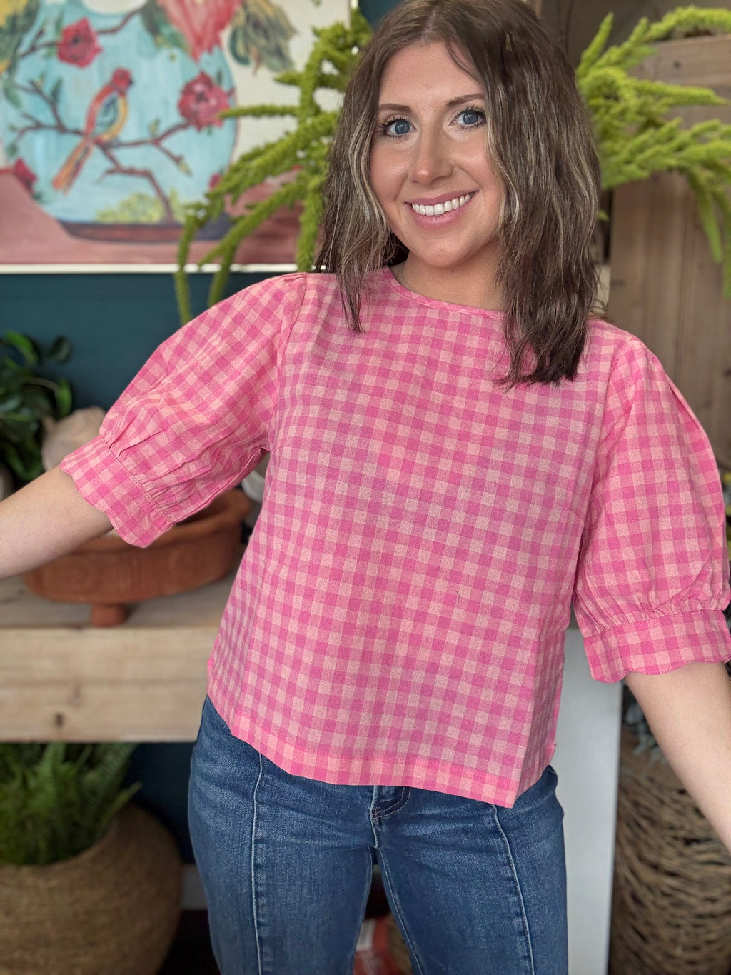woman wearing pink gingham puff sleeve boutique top