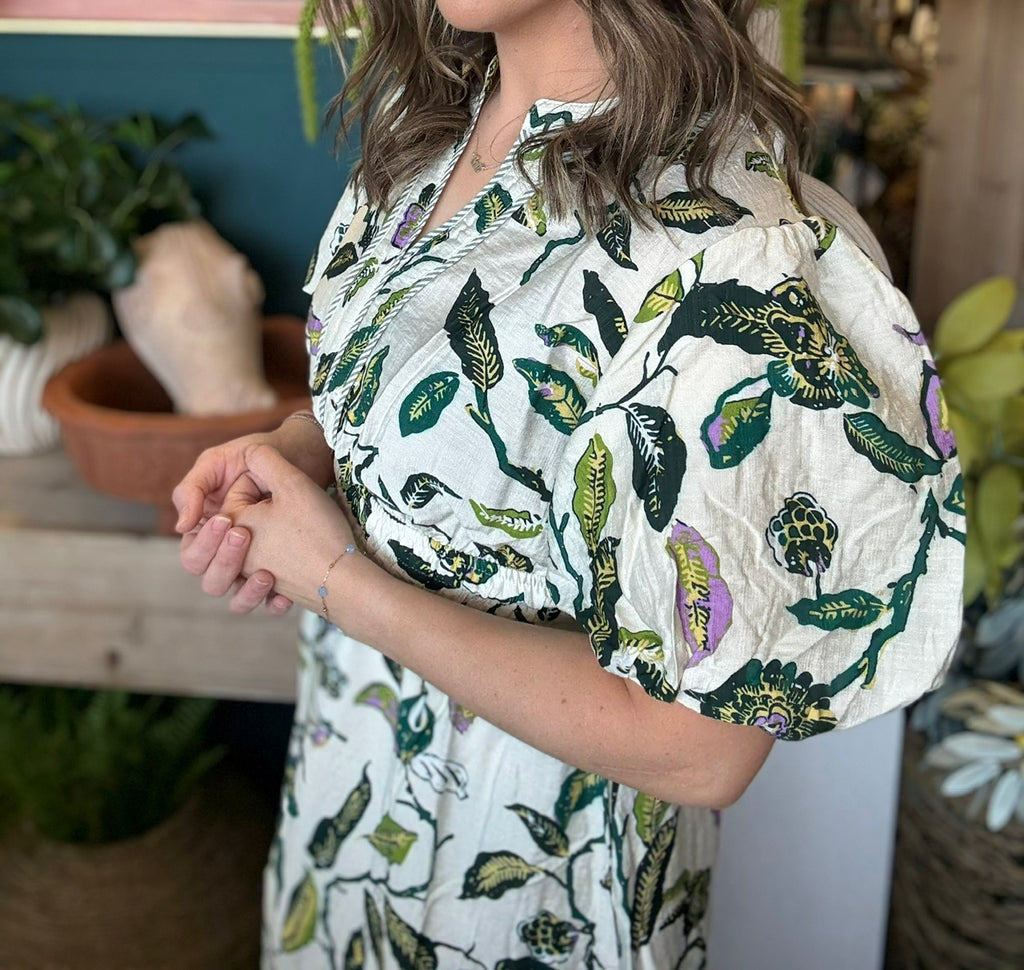 woman wearing woven botanical print mini dress with pockets