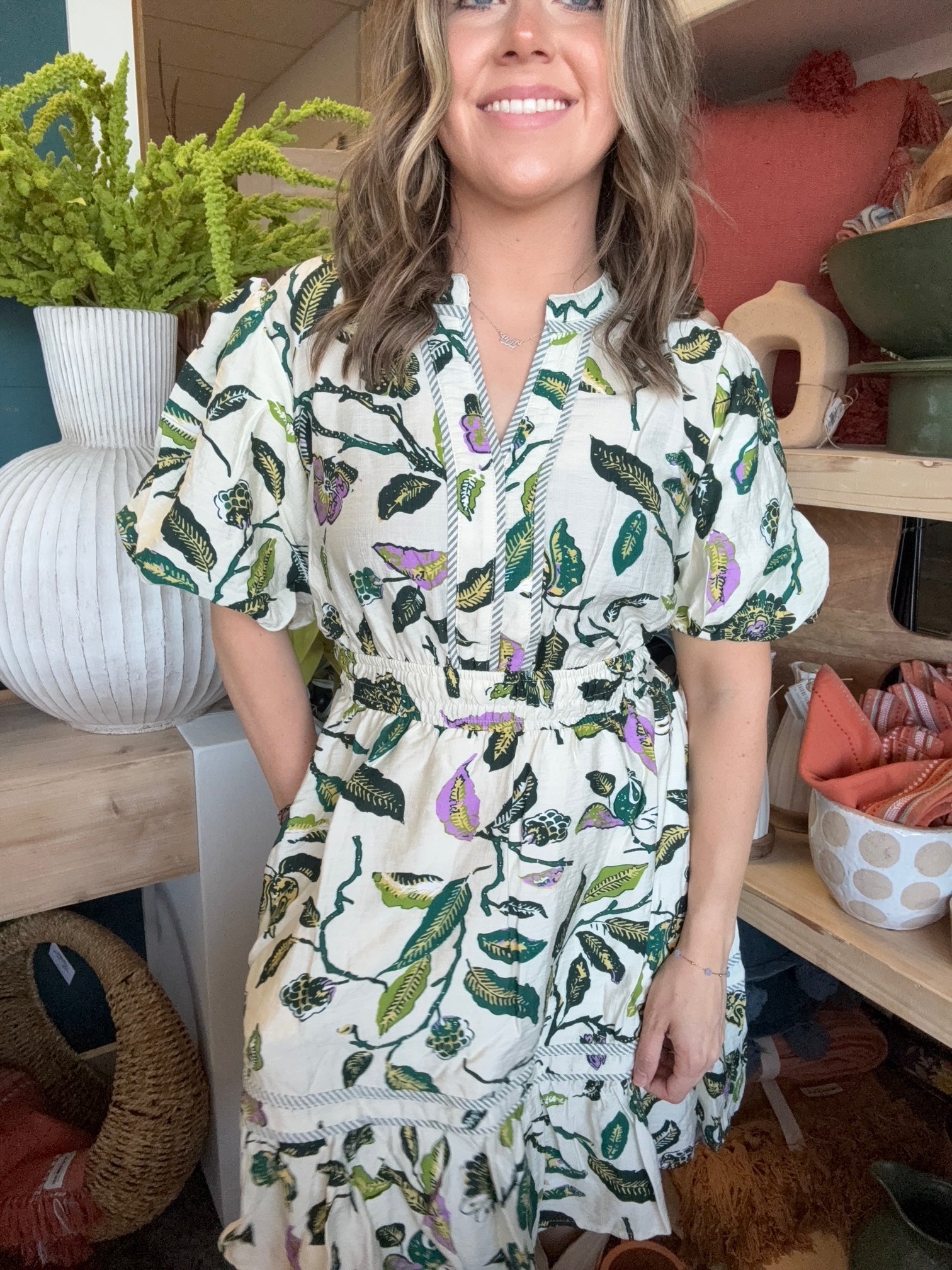 woman wearing woven botanical print mini dress with pockets