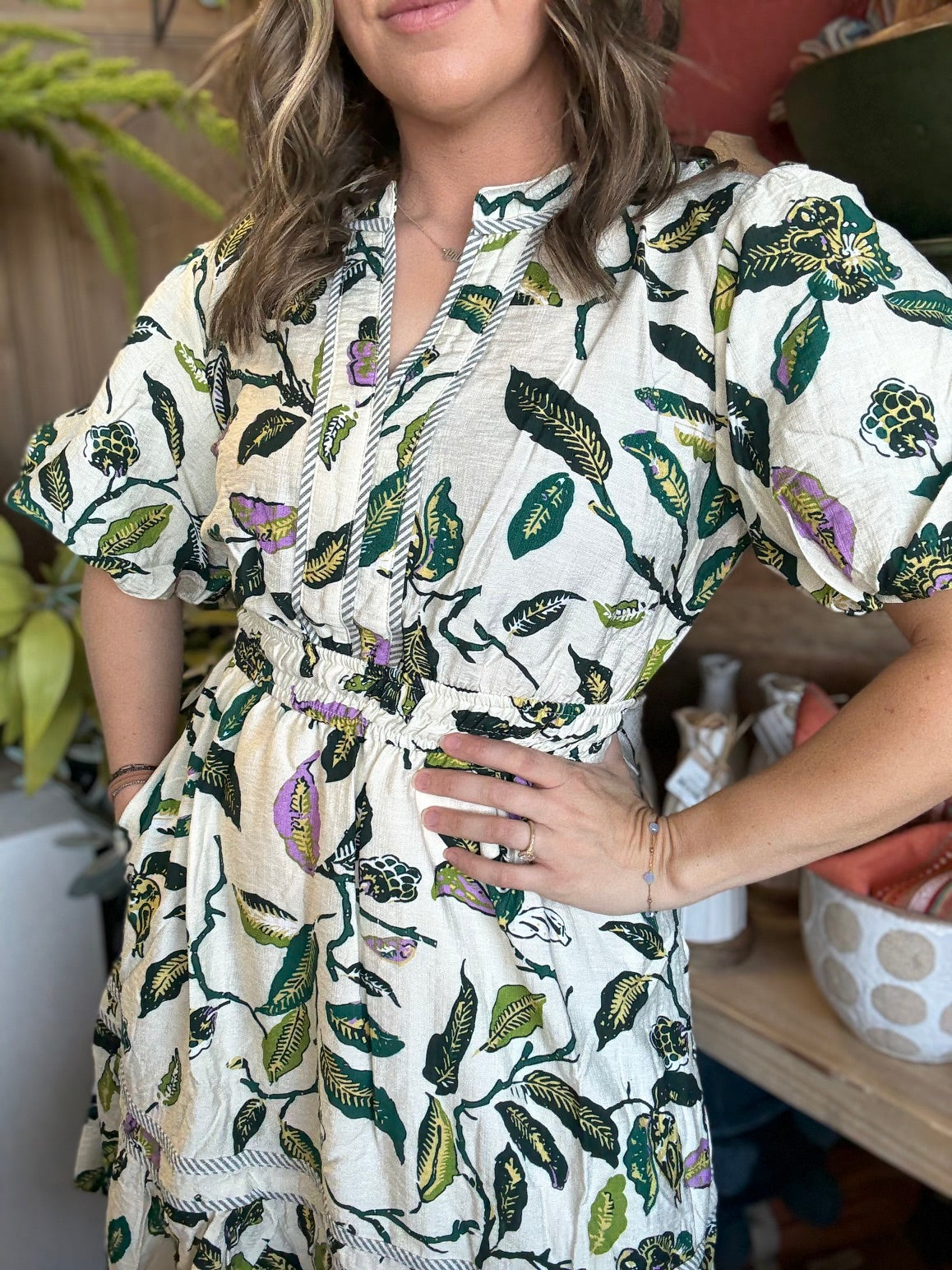 woman wearing woven botanical print mini dress with pockets