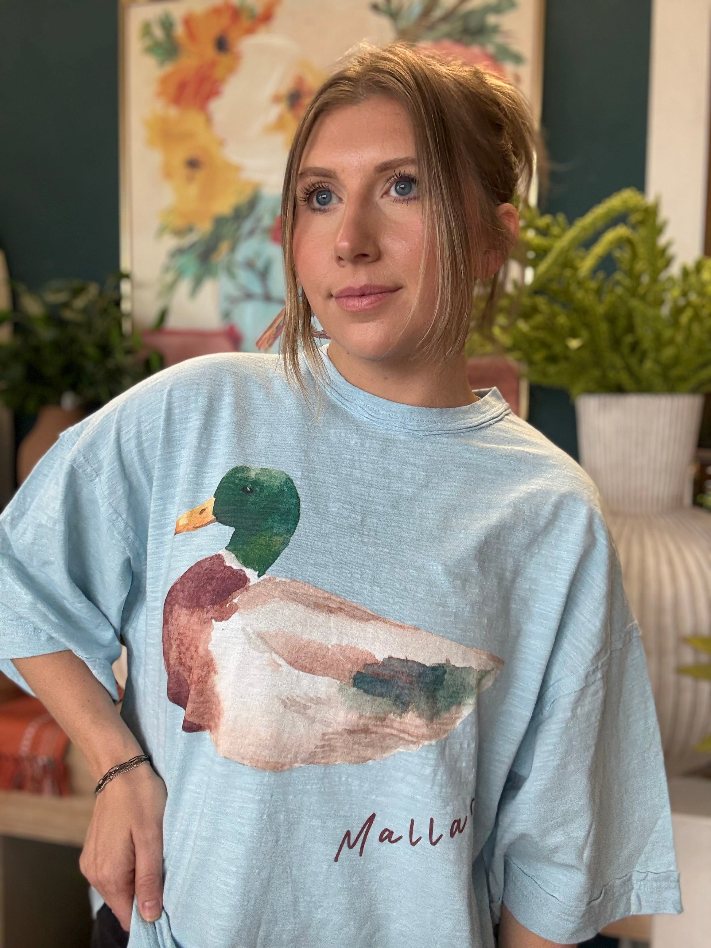 woman wearing light blue oversized graphic tee with watercolor mallard duck design
