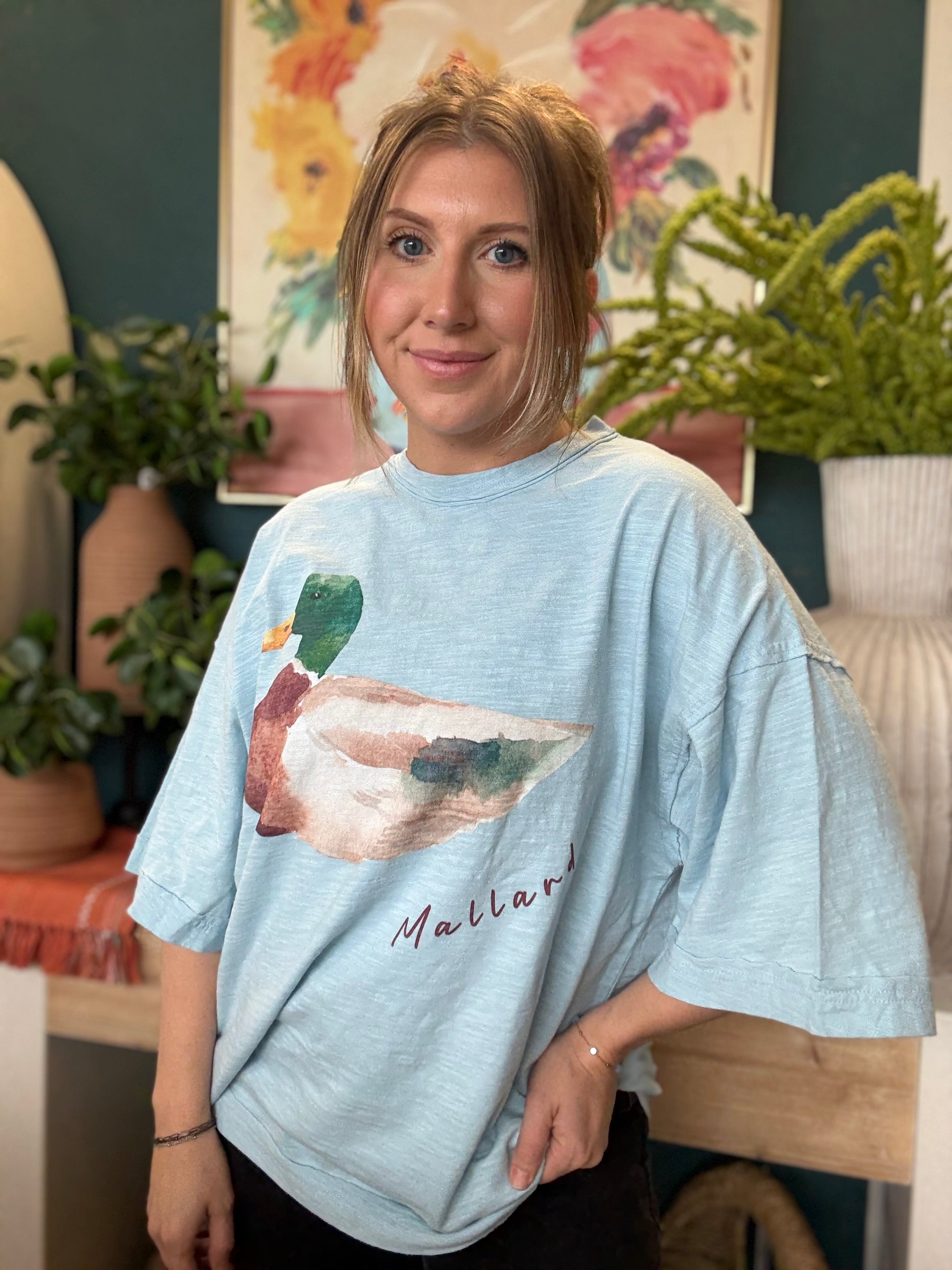 woman wearing light blue oversized graphic tee with watercolor mallard duck design