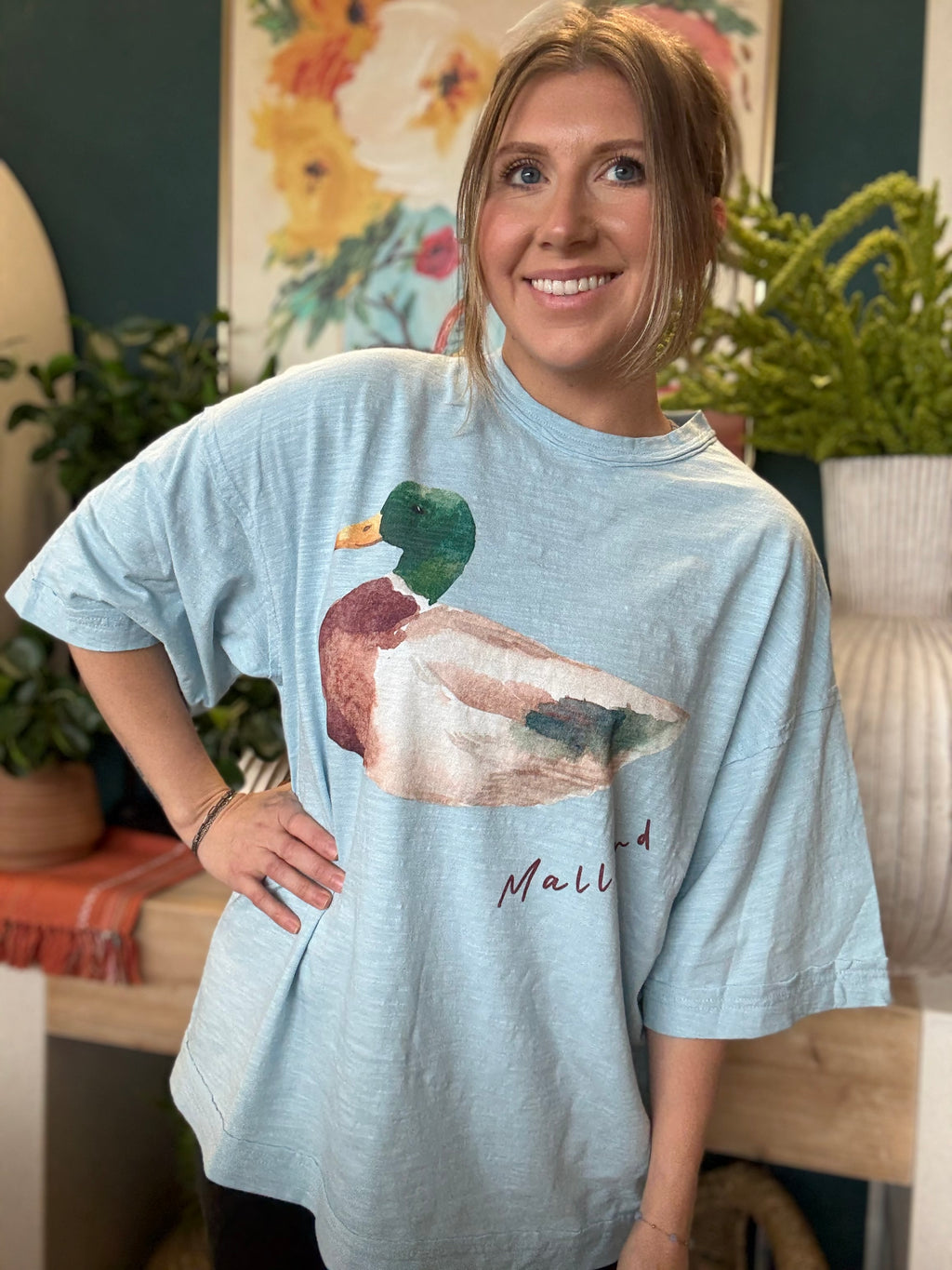 woman wearing light blue oversized graphic tee with watercolor mallard duck design