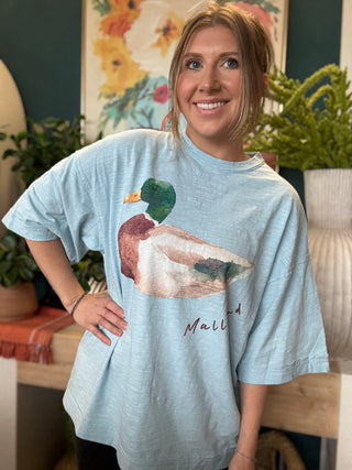 woman wearing light blue oversized graphic tee with watercolor mallard duck design