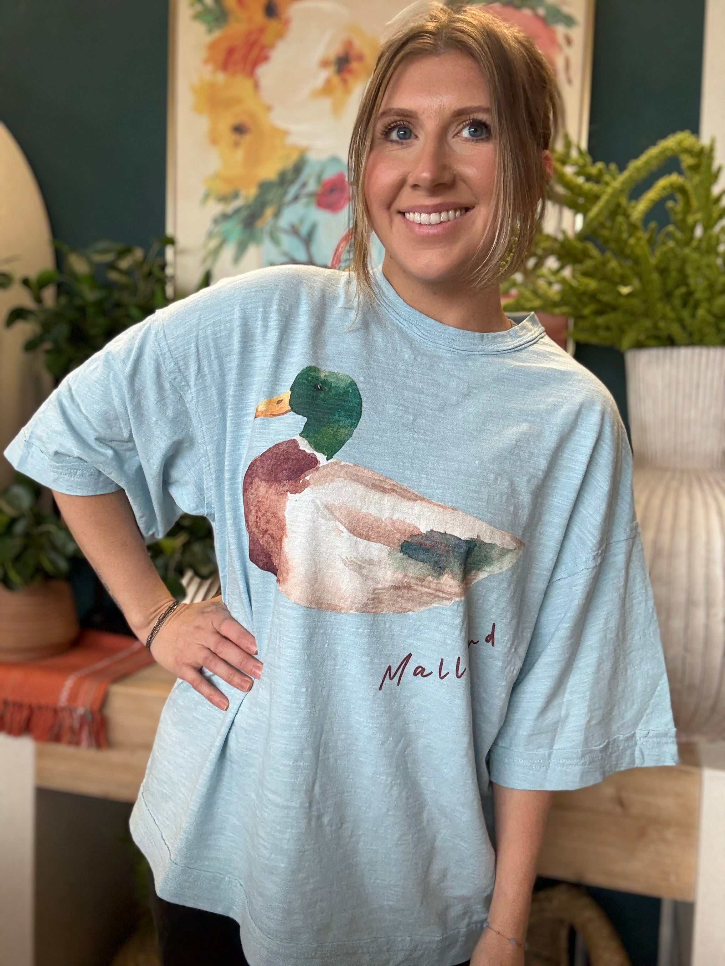woman wearing light blue oversized graphic tee with watercolor mallard duck design