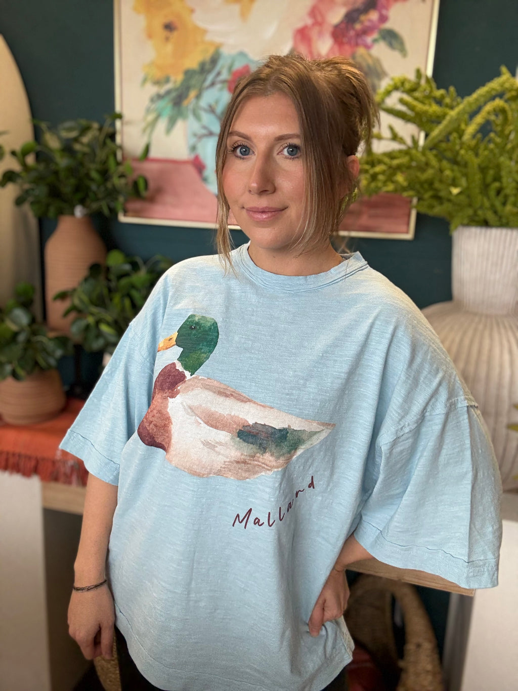 woman wearing light blue oversized graphic tee with watercolor mallard duck design