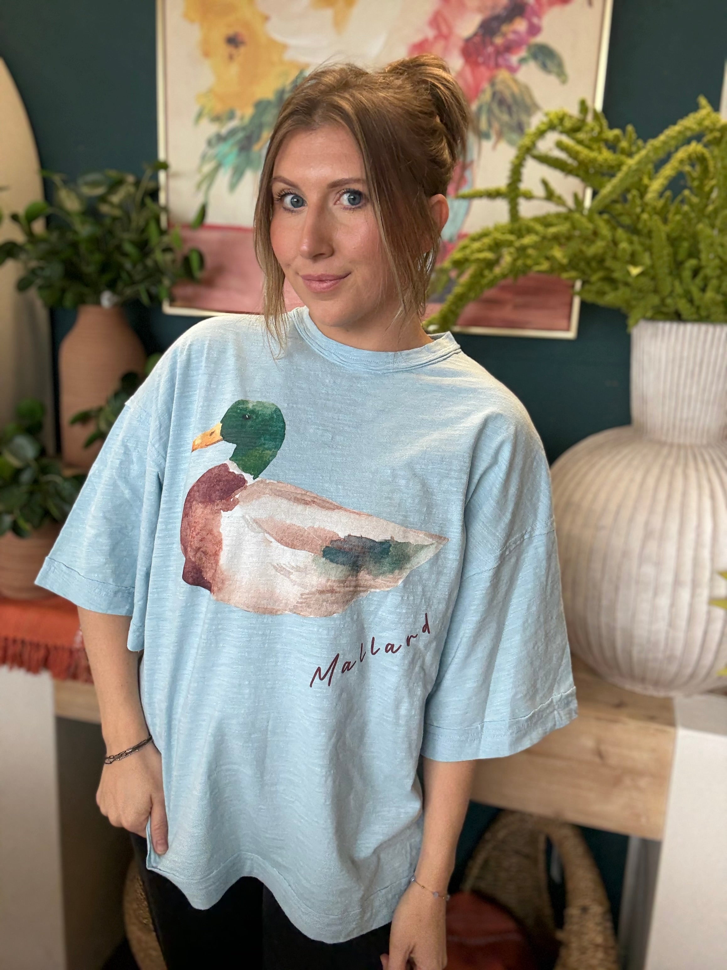 woman wearing light blue oversized graphic tee with watercolor mallard duck design