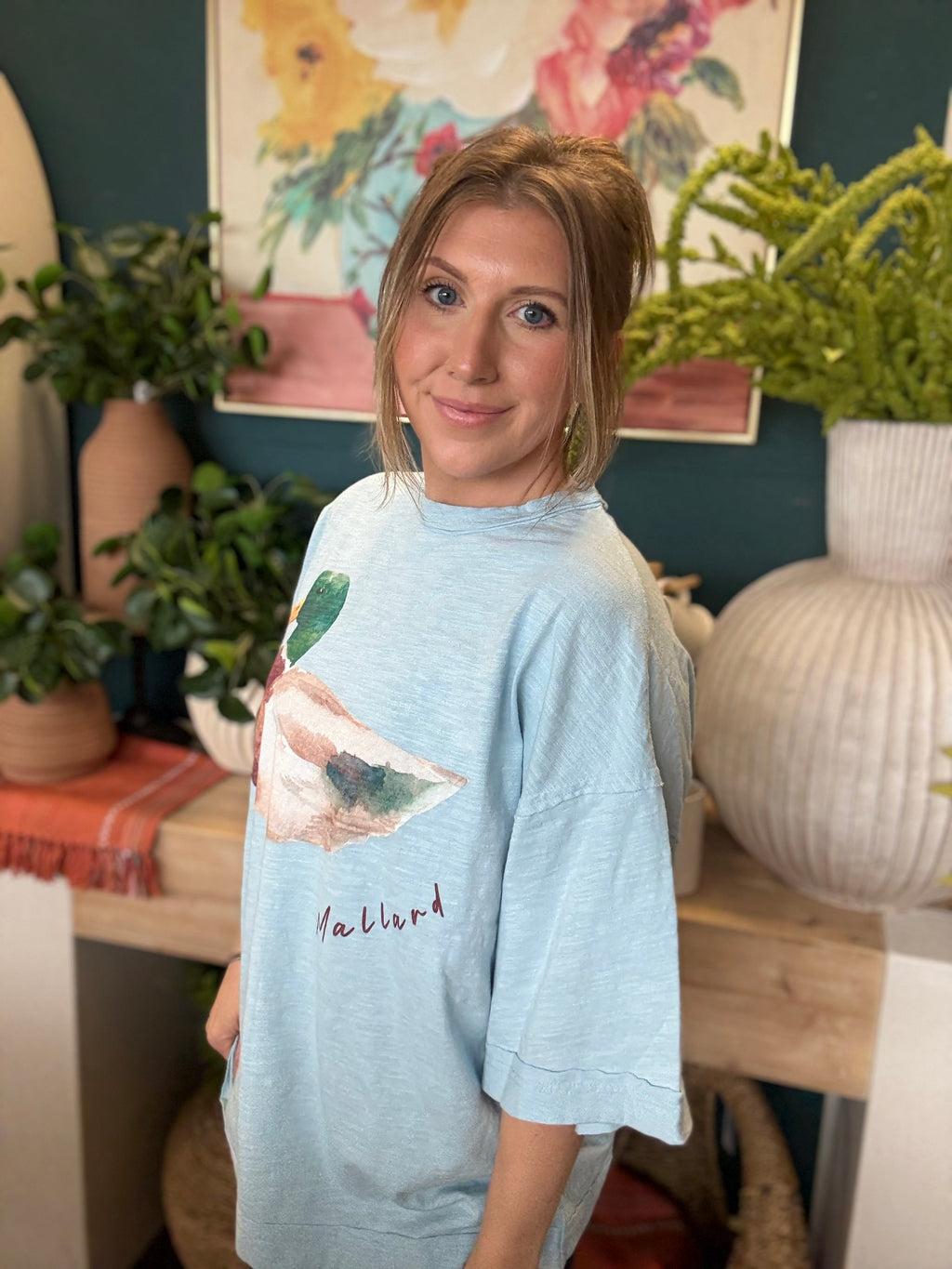 woman wearing light blue oversized graphic tee with watercolor mallard duck design