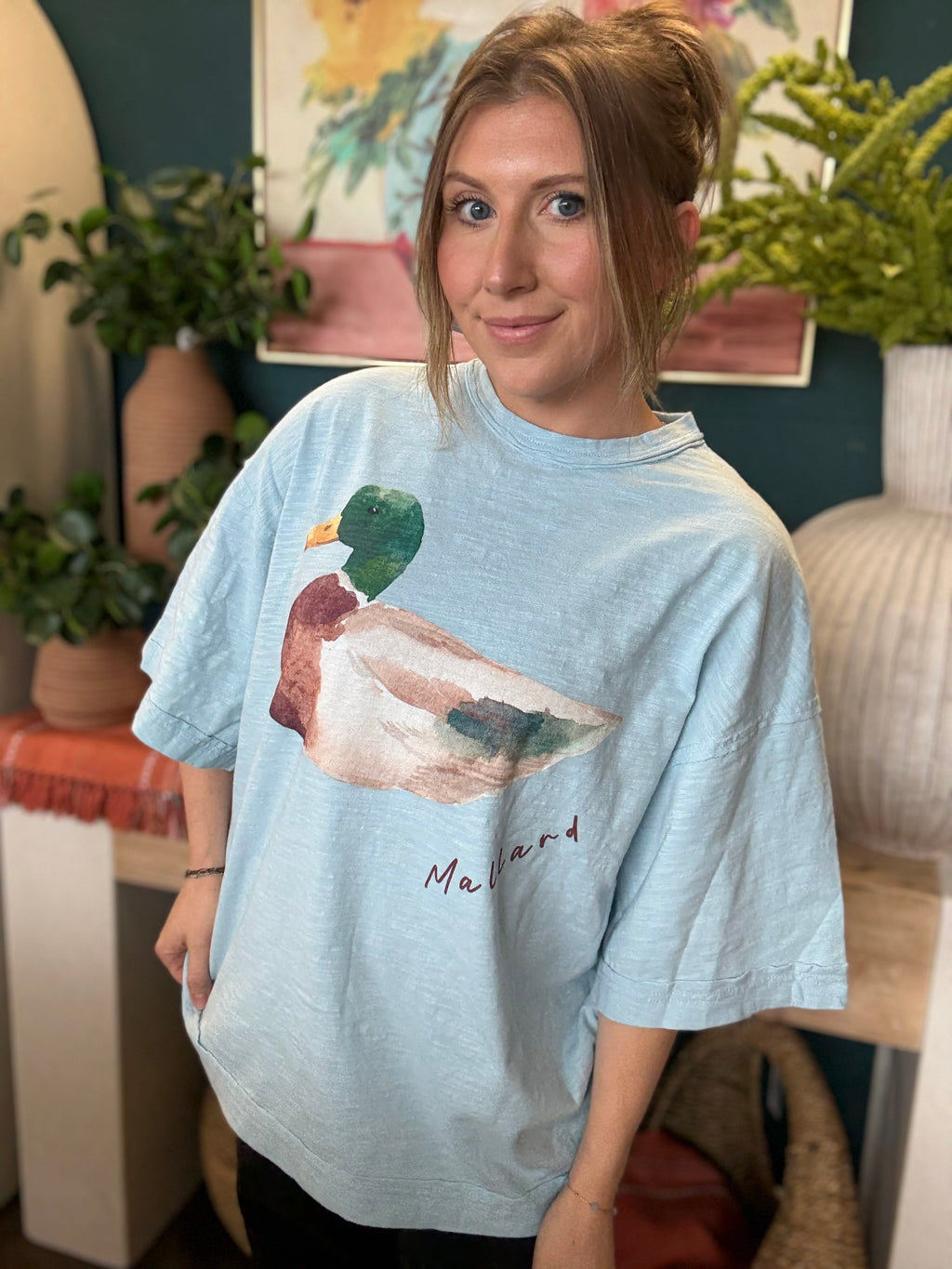 woman wearing light blue oversized graphic tee with watercolor mallard duck design