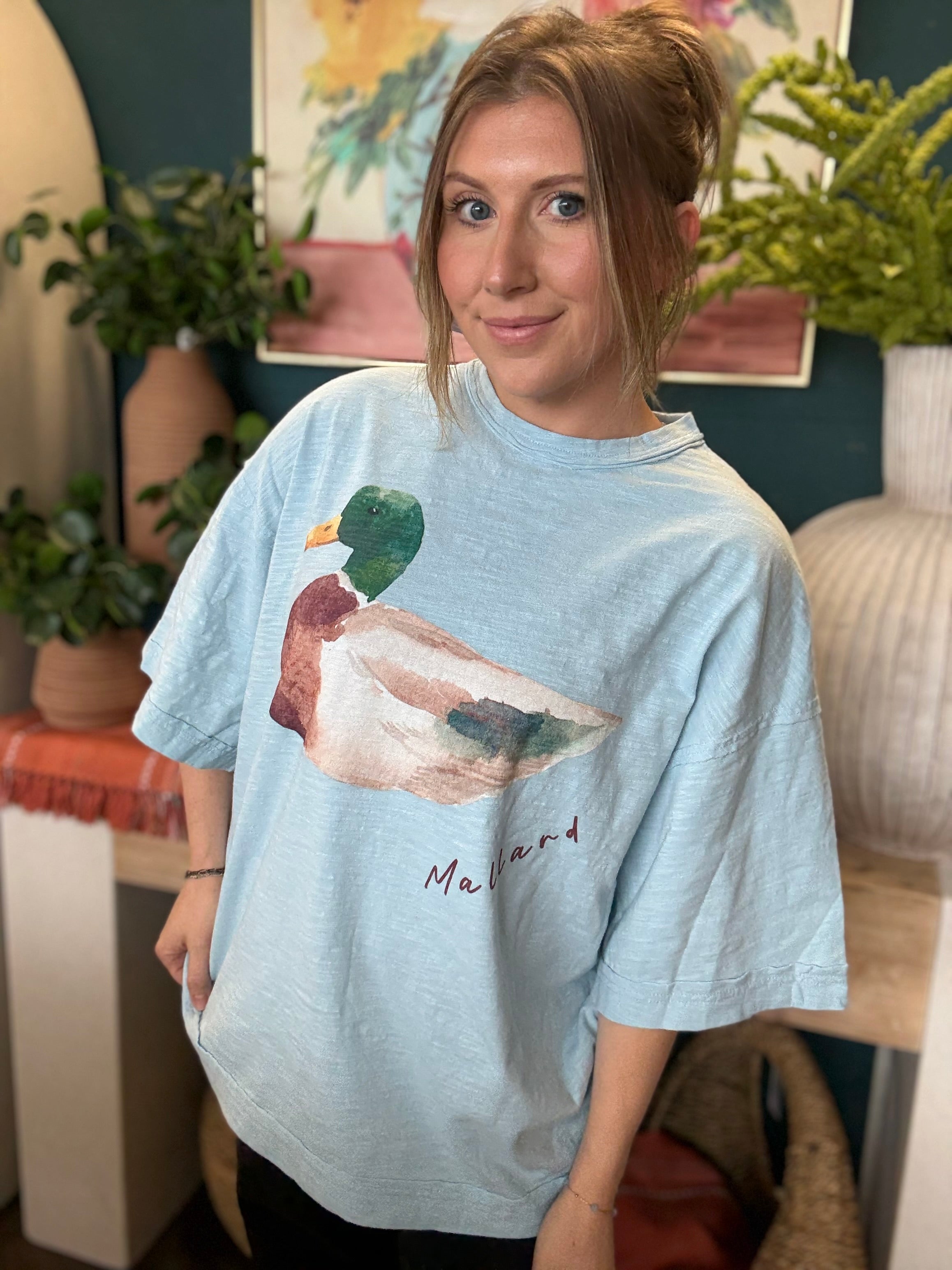 woman wearing light blue oversized graphic tee with watercolor mallard duck design