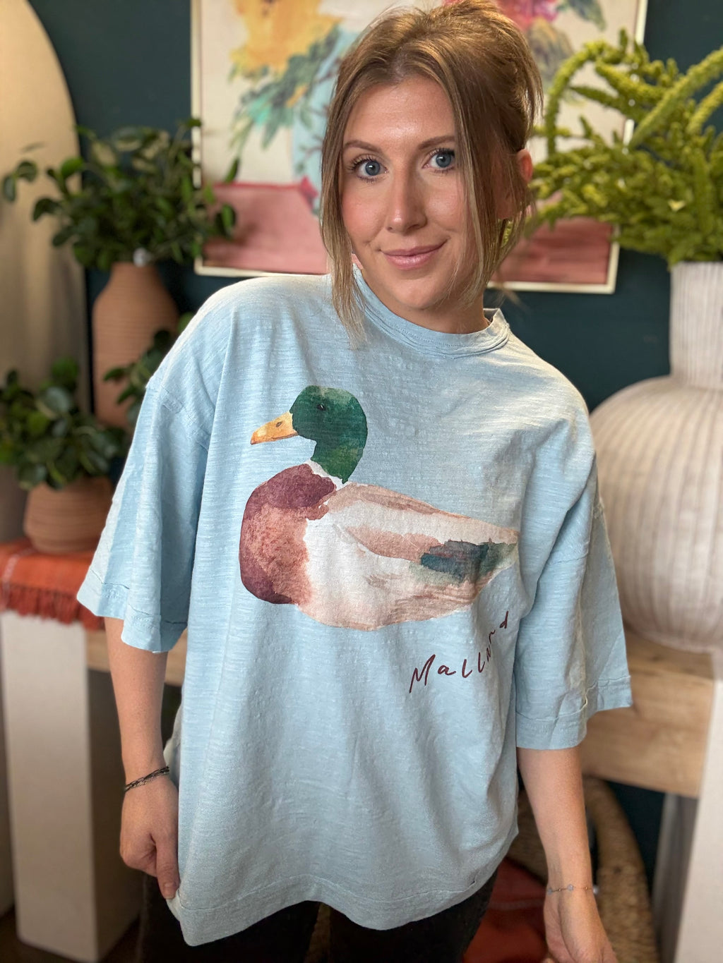 woman wearing light blue oversized graphic tee with watercolor mallard duck design