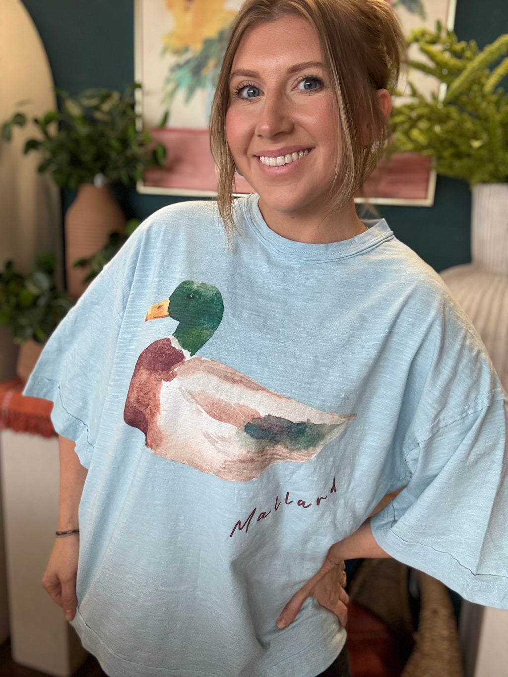 woman wearing light blue oversized graphic tee with watercolor mallard duck design