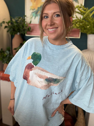 woman wearing light blue oversized graphic tee with watercolor mallard duck design