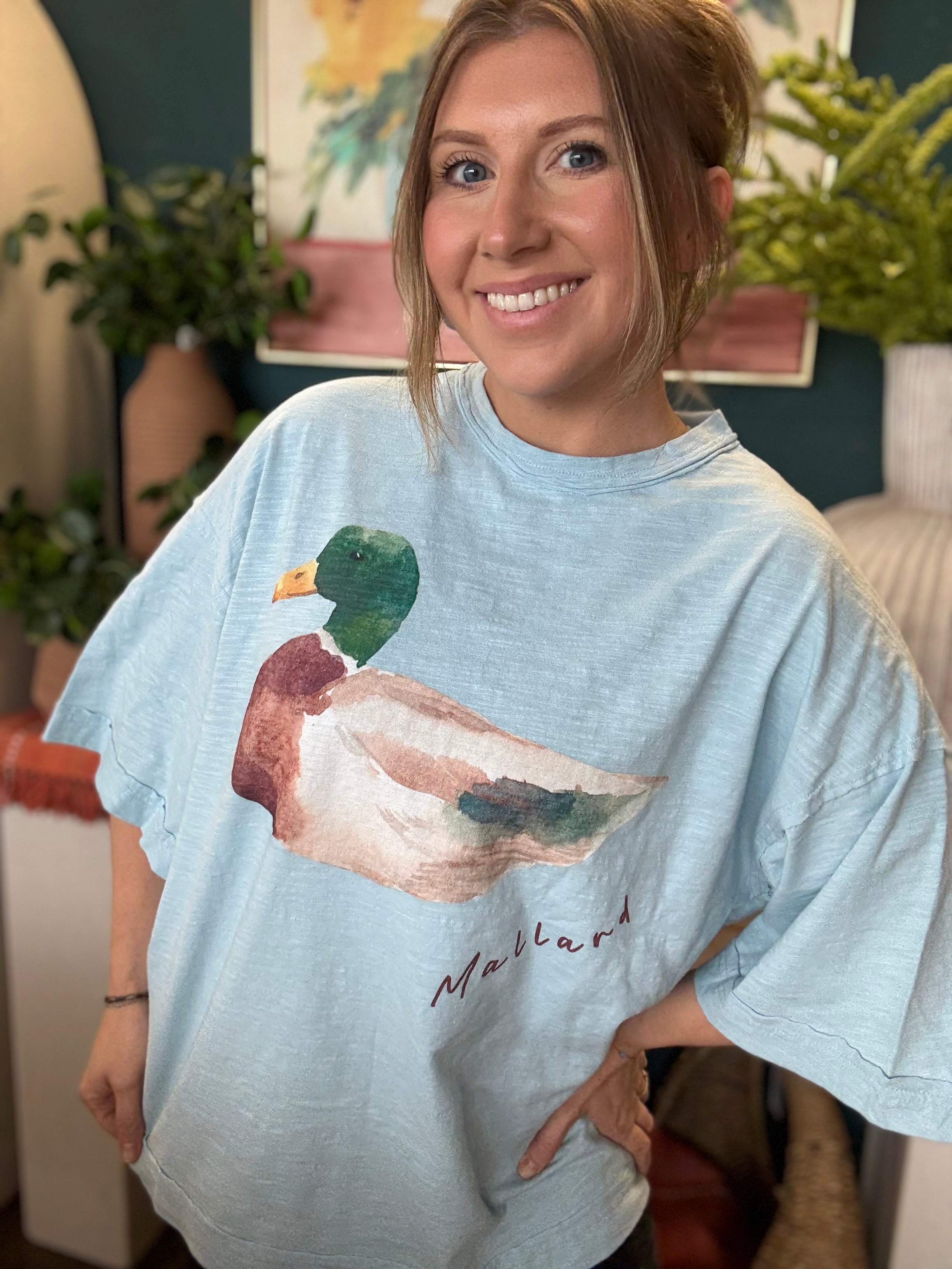woman wearing light blue oversized graphic tee with watercolor mallard duck design