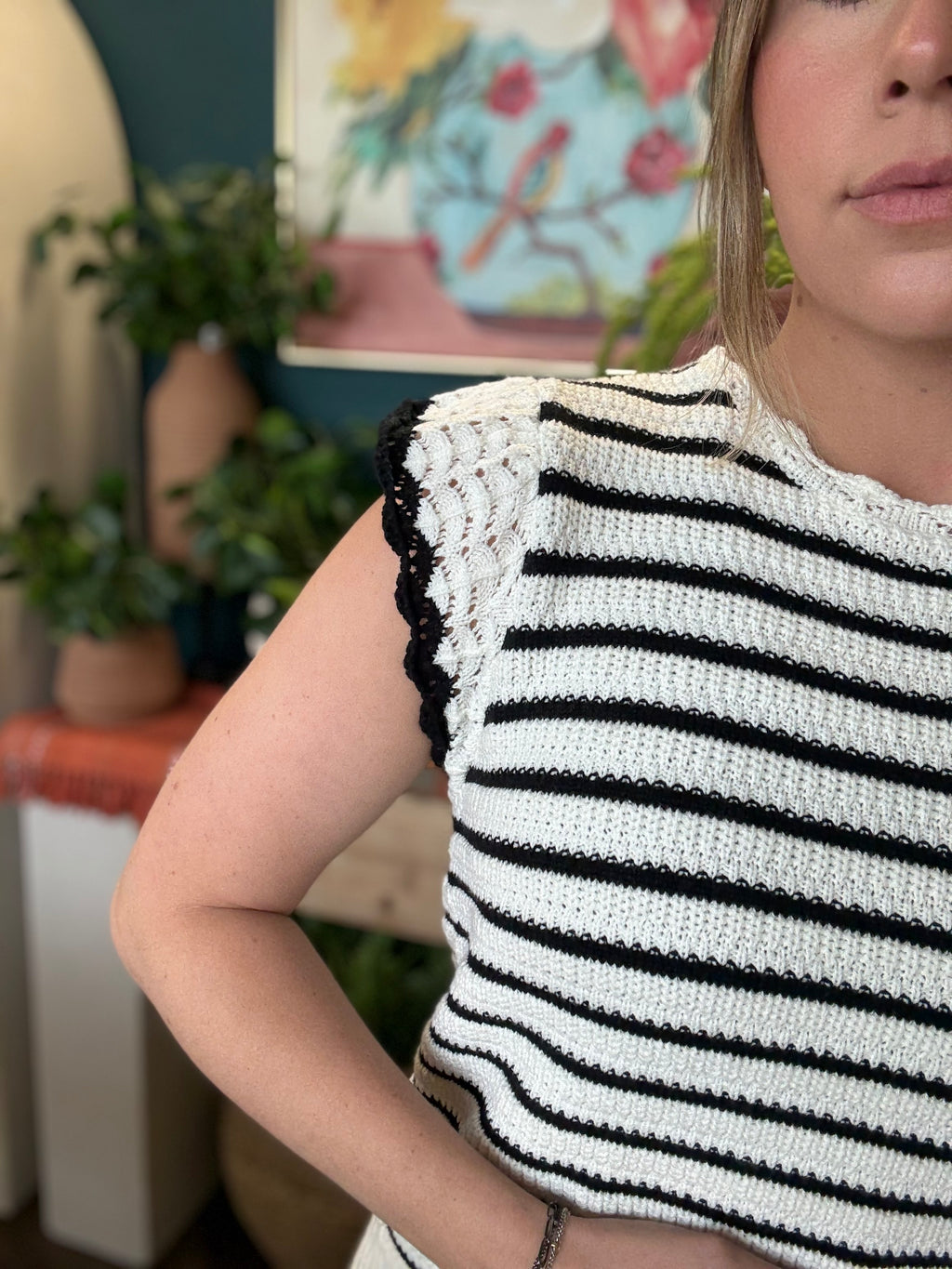 woman wearing black and ivory striped sweater top with crochet ruffle sleeves