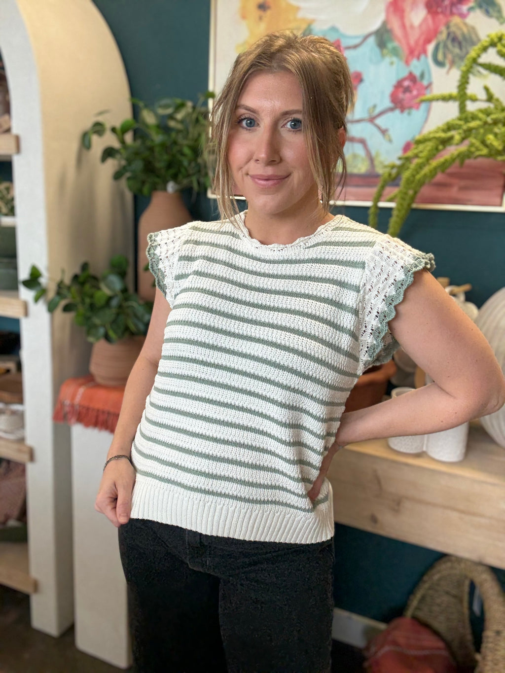 woman wearing sage and ivory striped sweater top with crochet ruffle sleeves