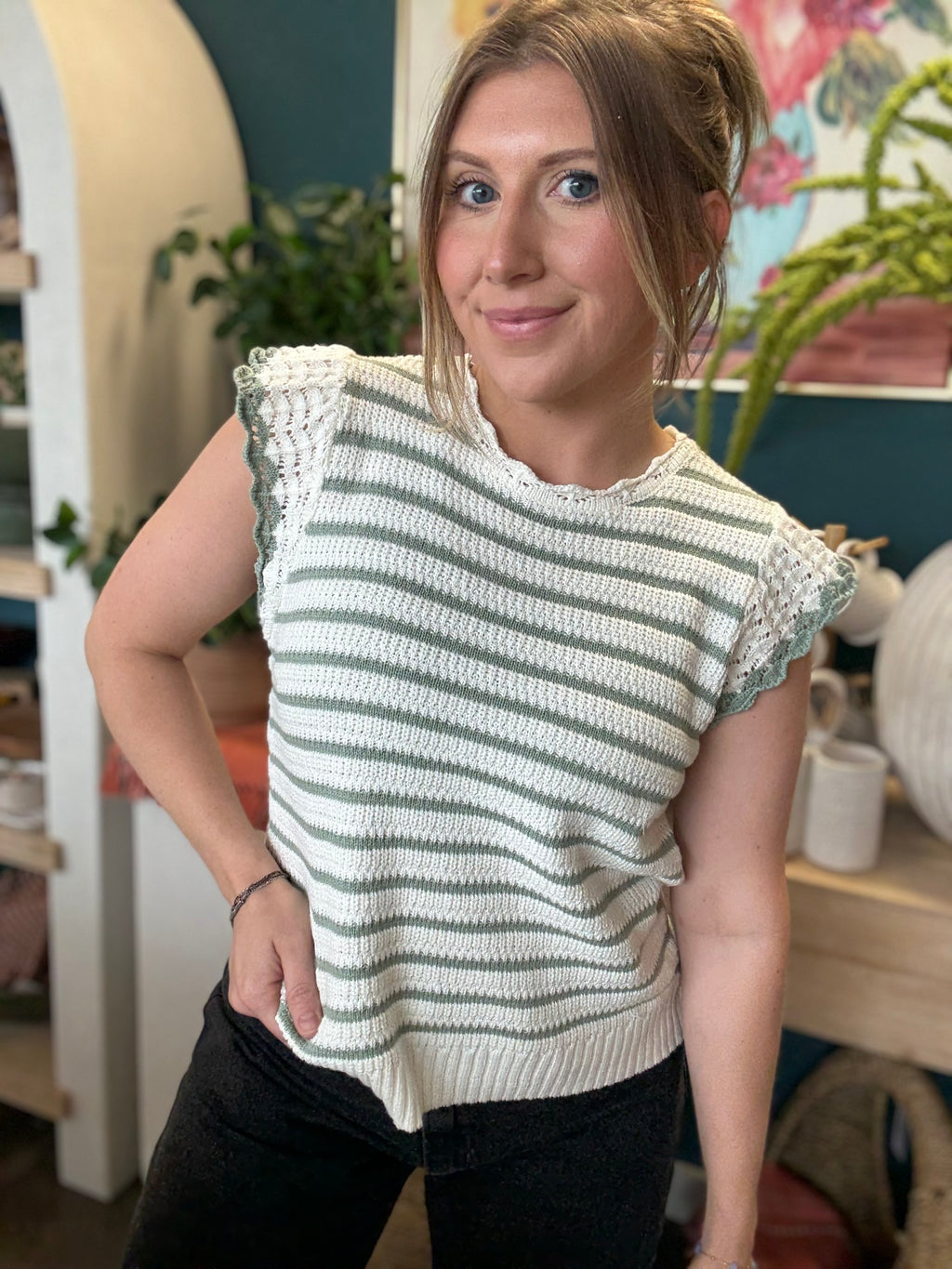 woman wearing sage and ivory striped sweater top with crochet ruffle sleeves
