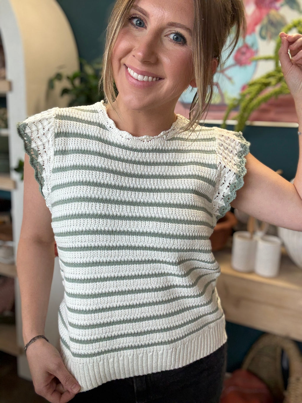 woman wearing sage and ivory striped sweater top with crochet ruffle sleeves
