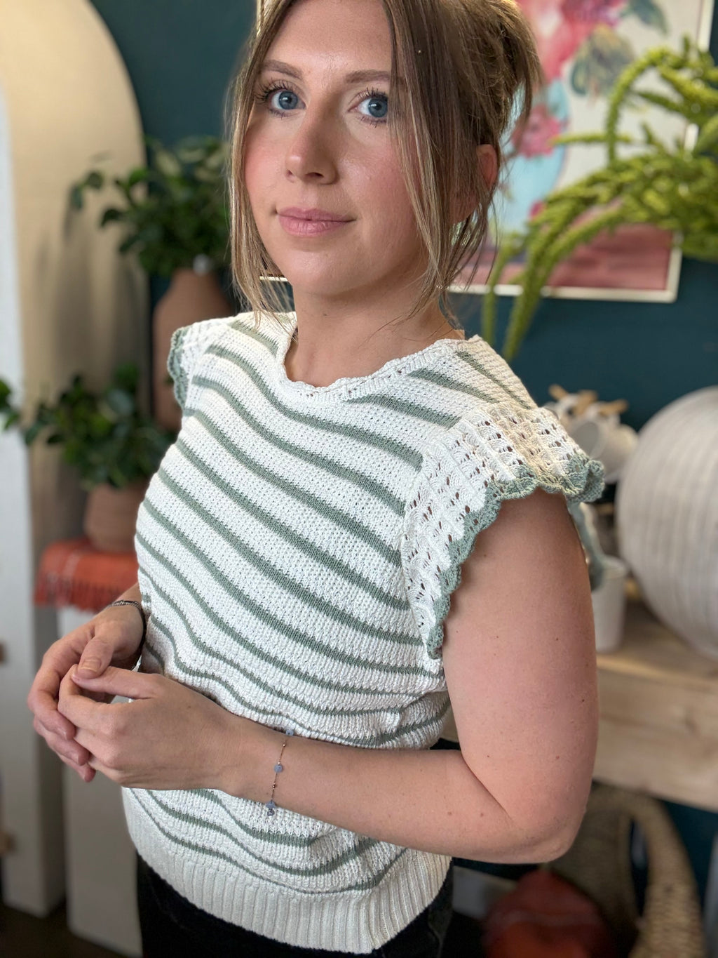 woman wearing sage and ivory striped sweater top with crochet ruffle sleeves