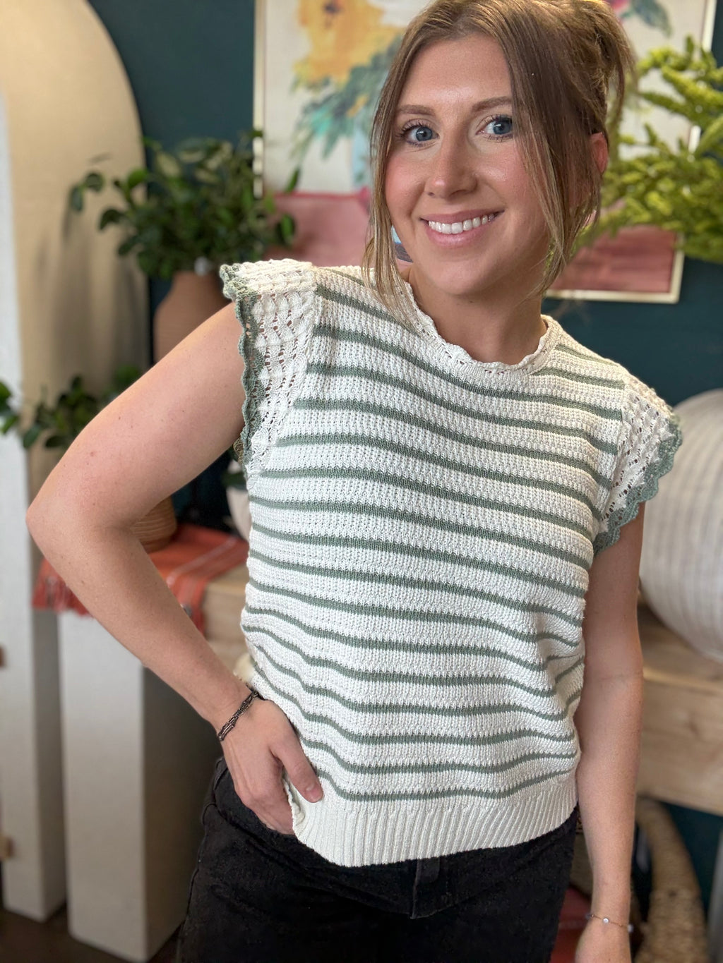 woman wearing sage and ivory striped sweater top with crochet ruffle sleeves