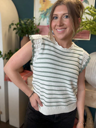 woman wearing sage and ivory striped sweater top with crochet ruffle sleeves