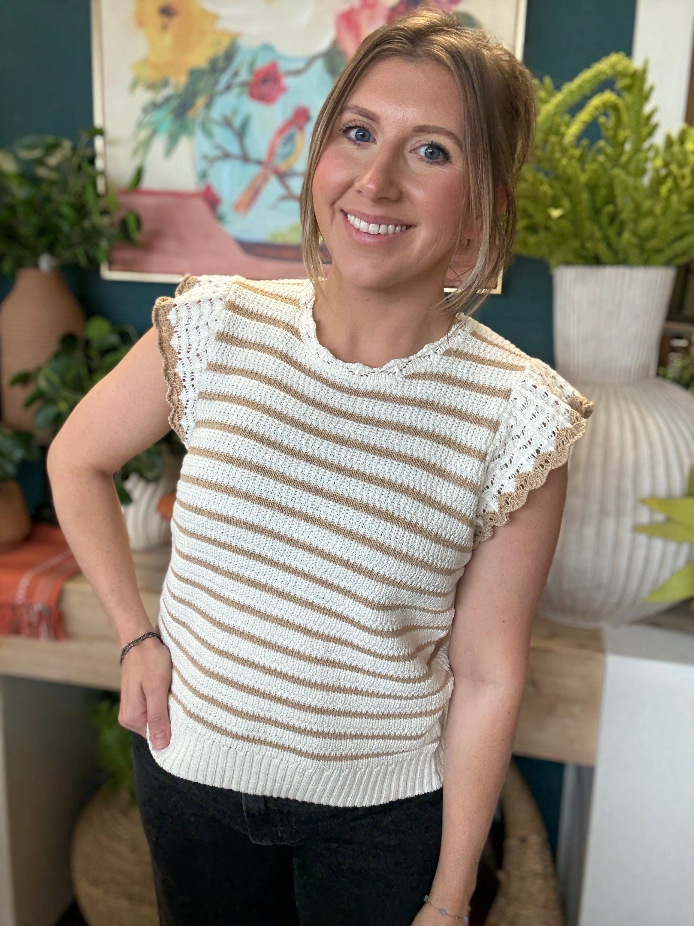 woman wearing taupe and ivory striped sweater top with crochet ruffle sleeves