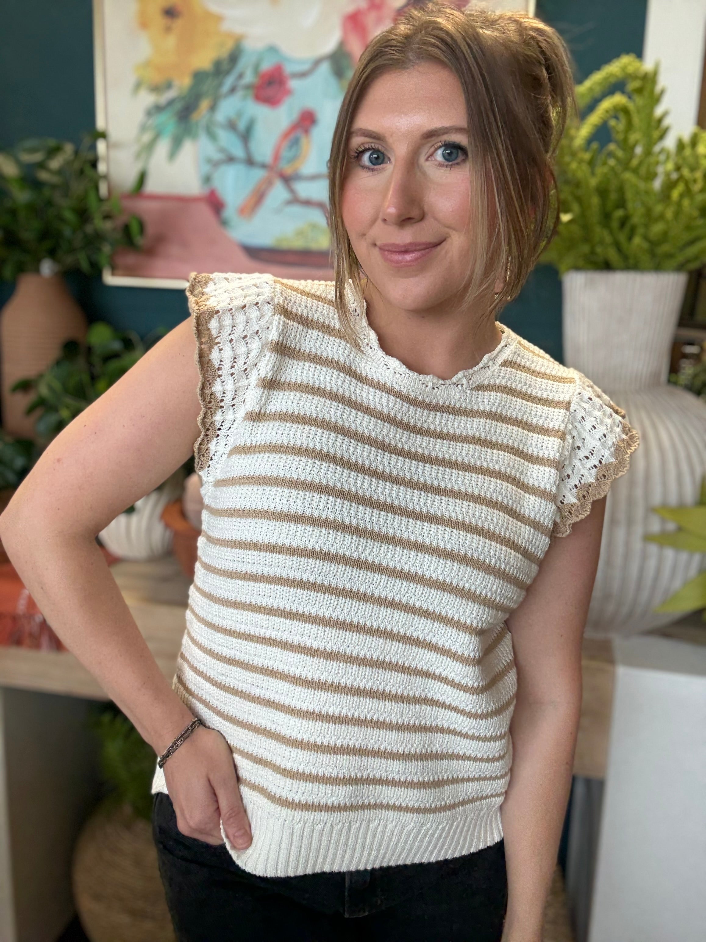 woman wearing taupe and ivory striped sweater top with crochet ruffle sleeves