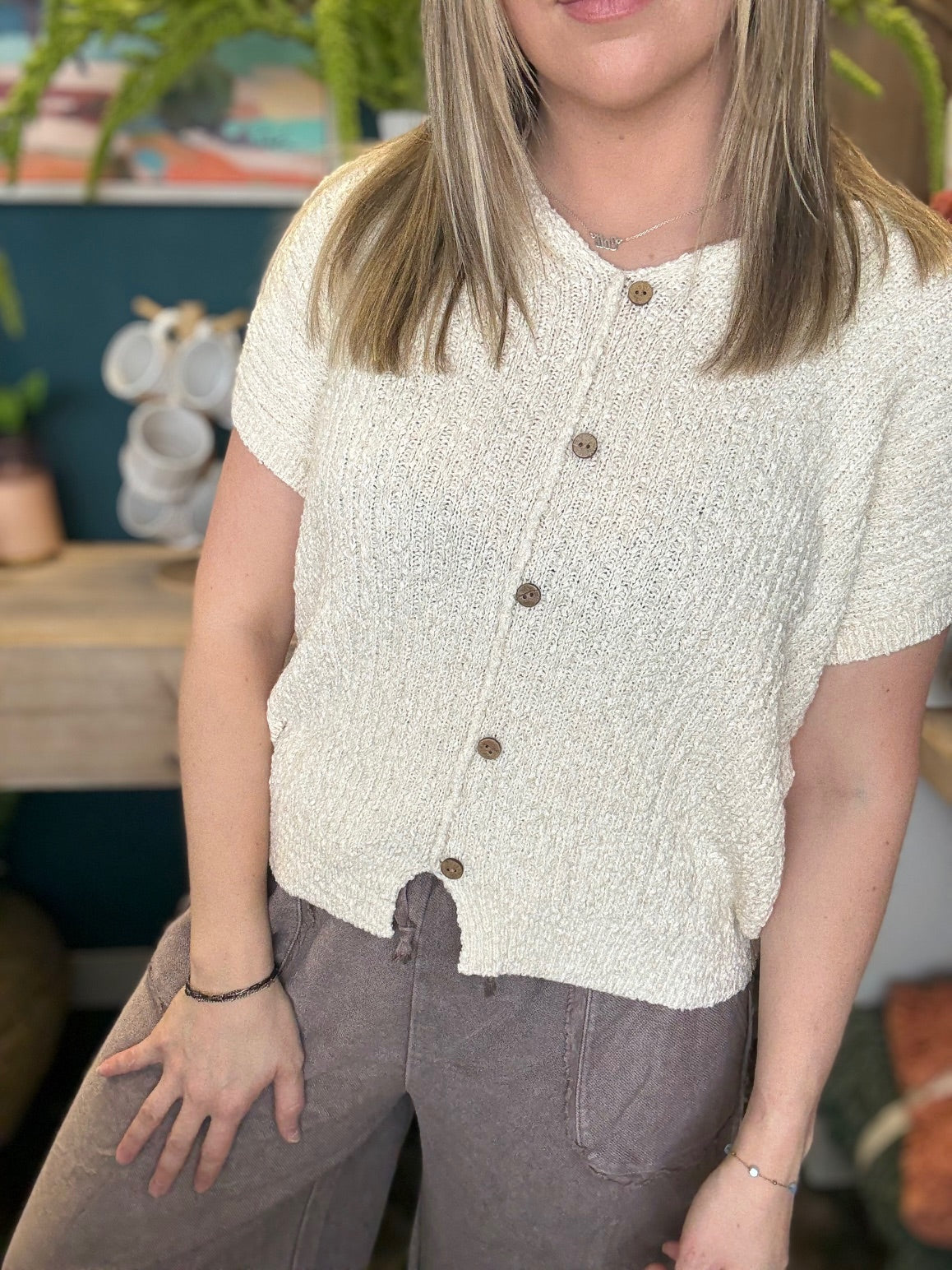 Cream textured button front boutique top styled with relaxed wide leg pants at Pill Box Boutique