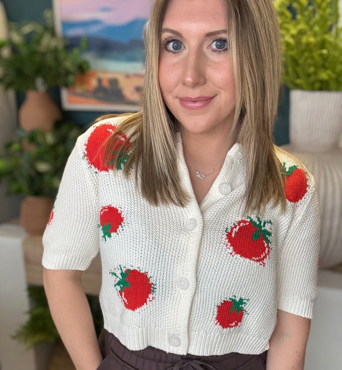 White knit strawberry button front boutique top styled with casual pants at Pill Box Boutique