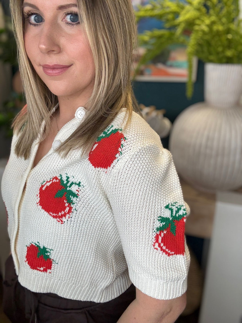 White knit strawberry button front boutique top styled with casual pants at Pill Box Boutique