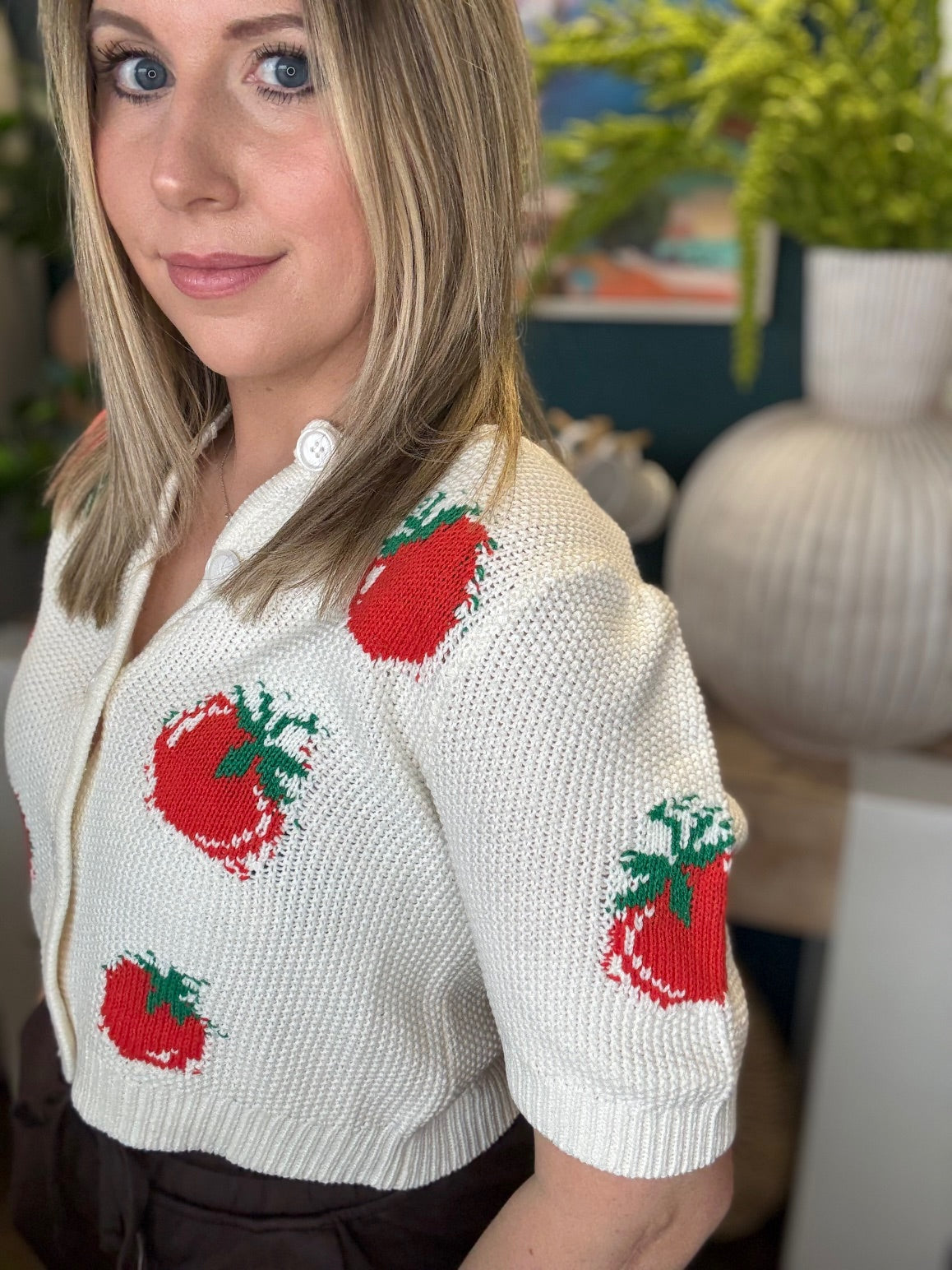 White knit strawberry button front boutique top styled with casual pants at Pill Box Boutique