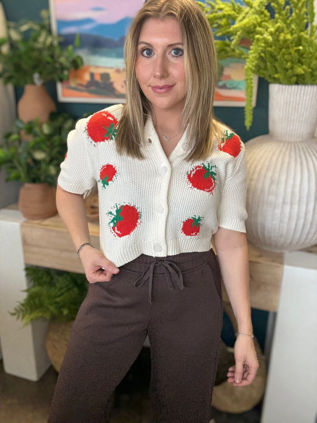 White knit strawberry button front boutique top styled with casual pants at Pill Box Boutique