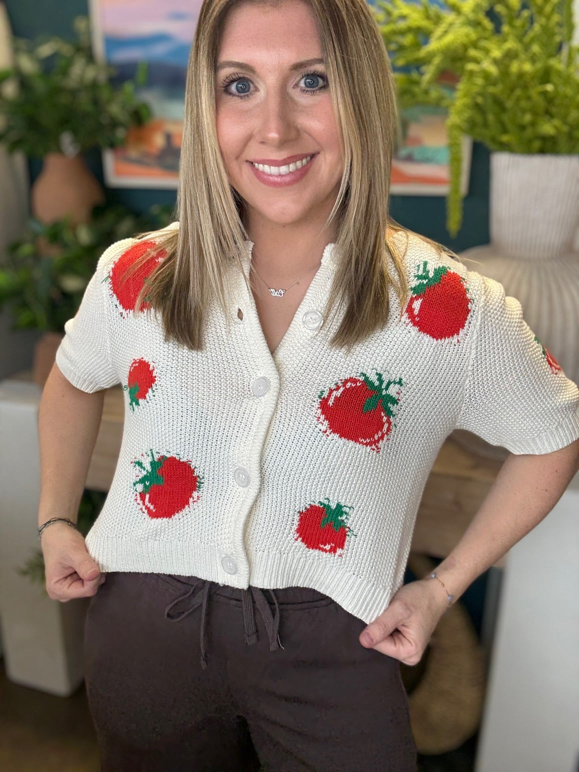 White knit strawberry button front boutique top styled with casual pants at Pill Box Boutique
