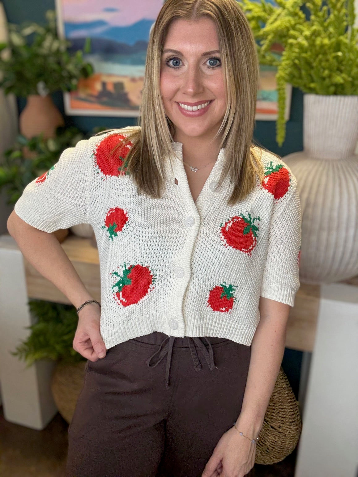 White knit strawberry button front boutique top styled with casual pants at Pill Box Boutique