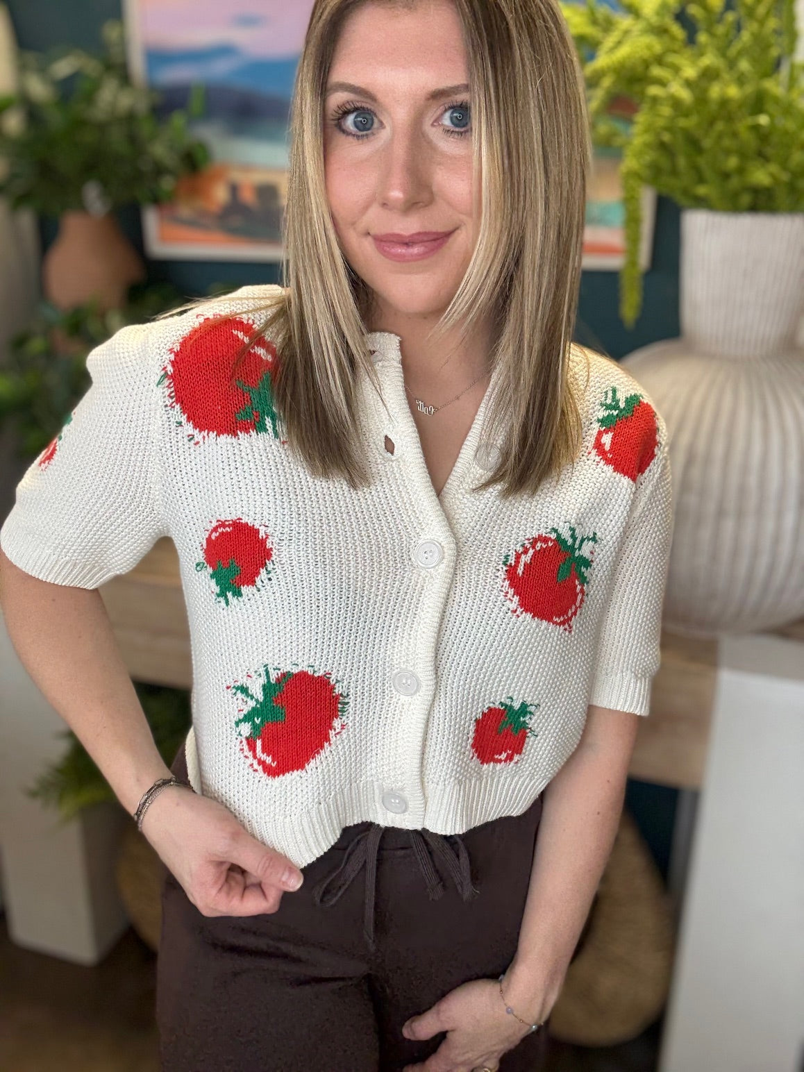 White knit strawberry button front boutique top styled with casual pants at Pill Box Boutique