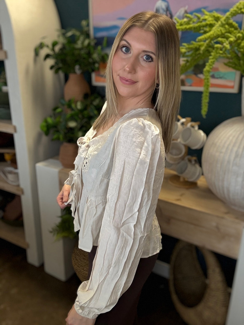 Cream embroidered tie front boutique top with floral detail styled with casual pants at Pill Box Boutique