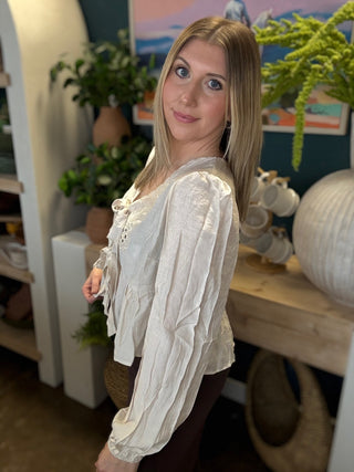Cream embroidered tie front boutique top with floral detail styled with casual pants at Pill Box Boutique