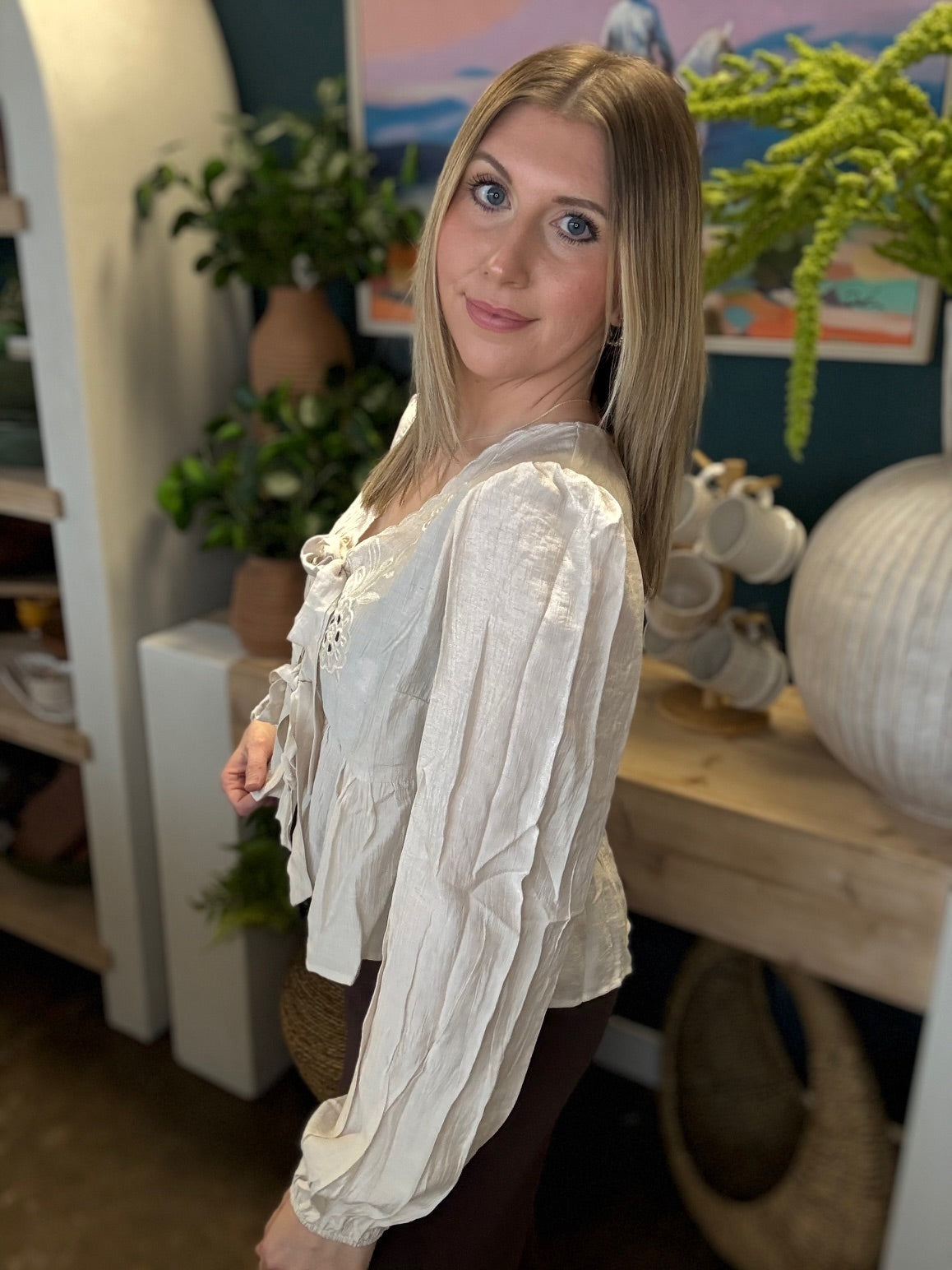 Cream embroidered tie front boutique top with floral detail styled with casual pants at Pill Box Boutique