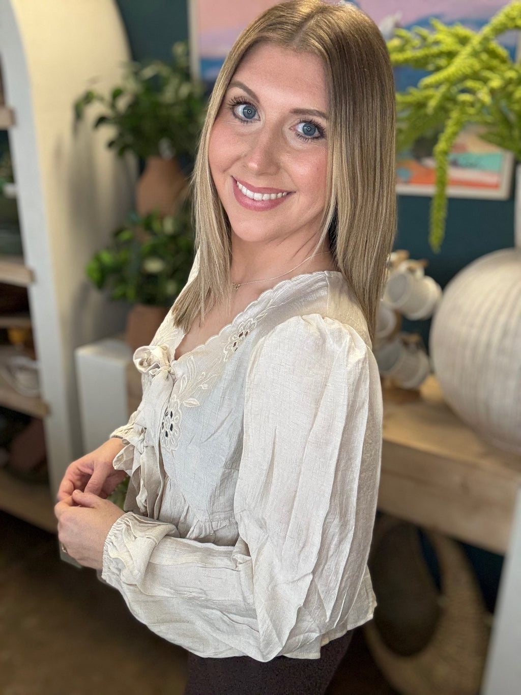 Cream embroidered tie front boutique top with floral detail styled with casual pants at Pill Box Boutique