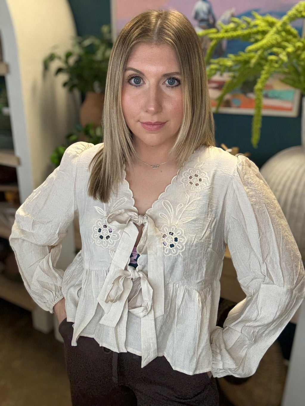Cream embroidered tie front boutique top with floral detail styled with casual pants at Pill Box Boutique