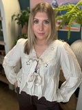 Cream embroidered tie front boutique top with floral detail styled with casual pants at Pill Box Boutique
