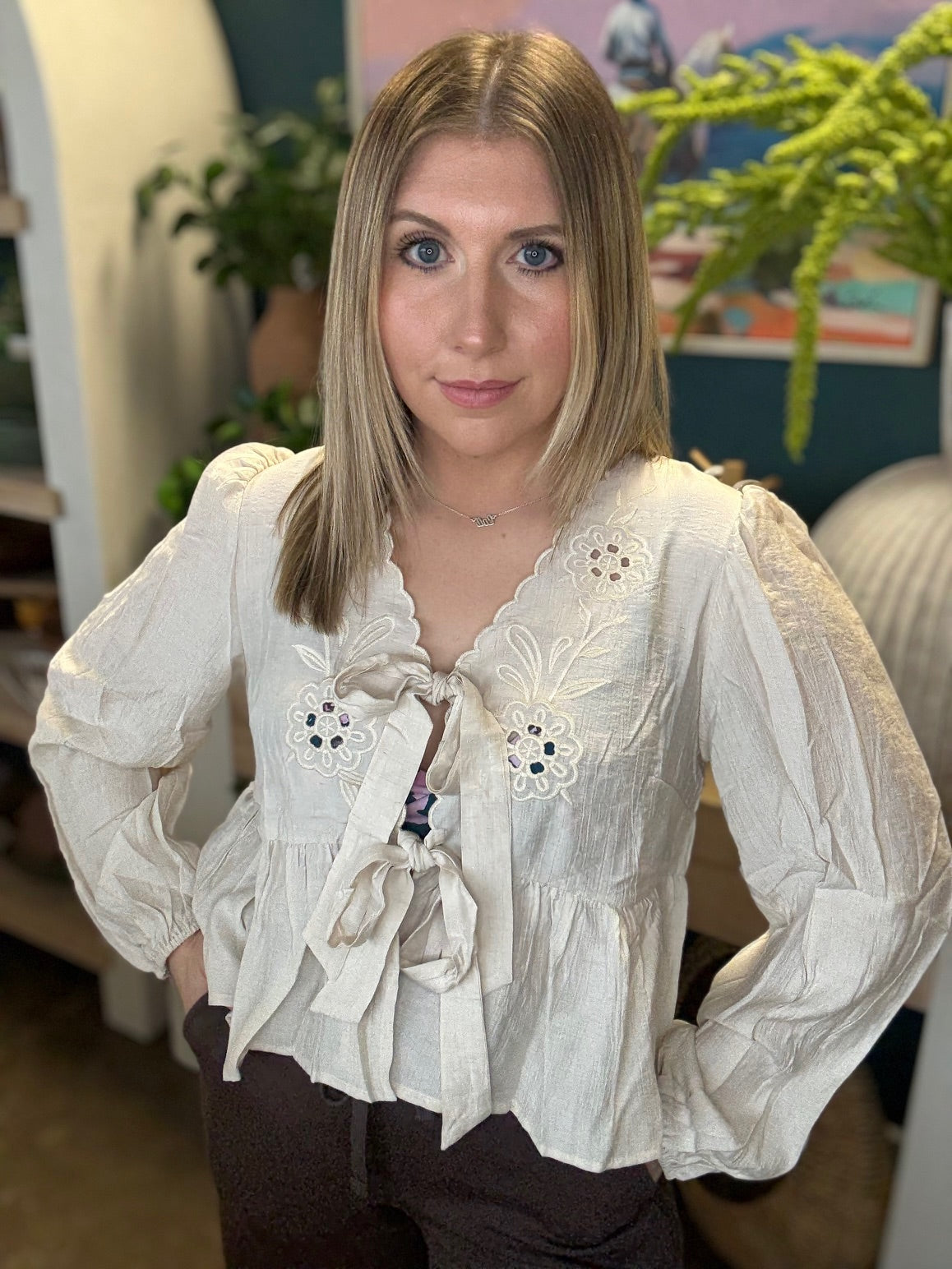 Cream embroidered tie front boutique top with floral detail styled with casual pants at Pill Box Boutique