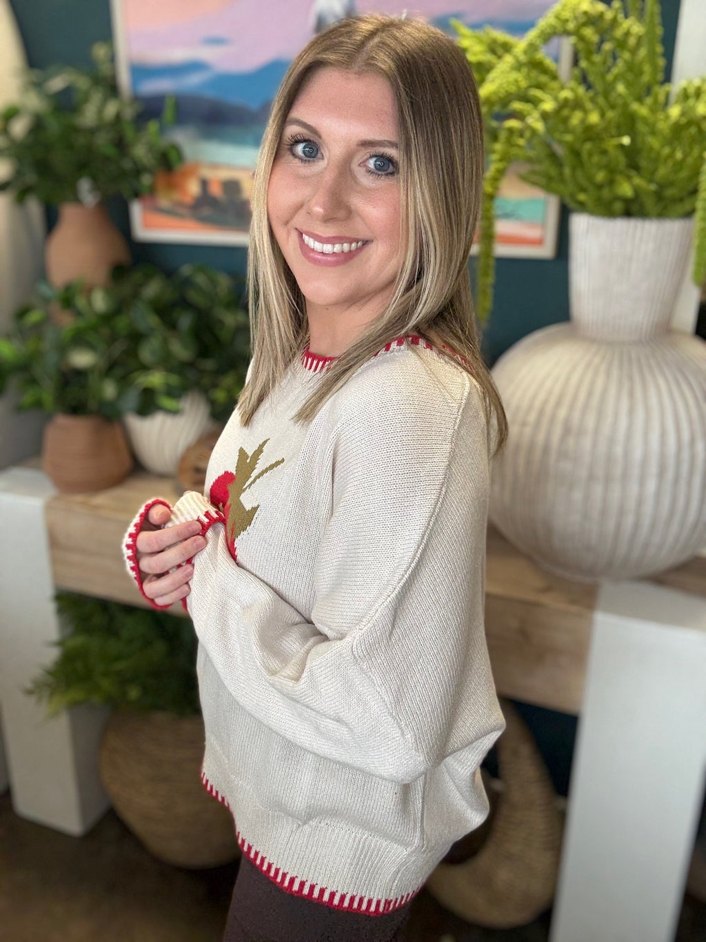 Strawberry graphic knit boutique sweater with contrast stitching styled with casual pants at Pill Box Boutique