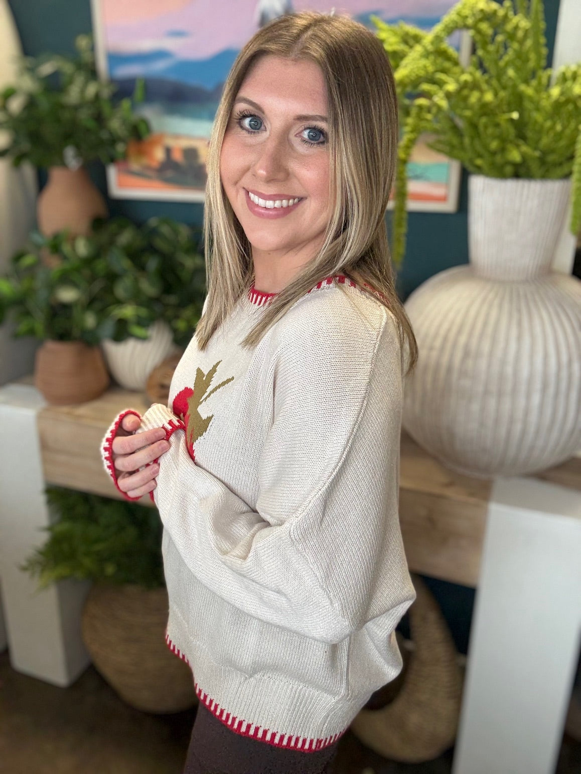 Strawberry graphic knit boutique sweater with contrast stitching styled with casual pants at Pill Box Boutique