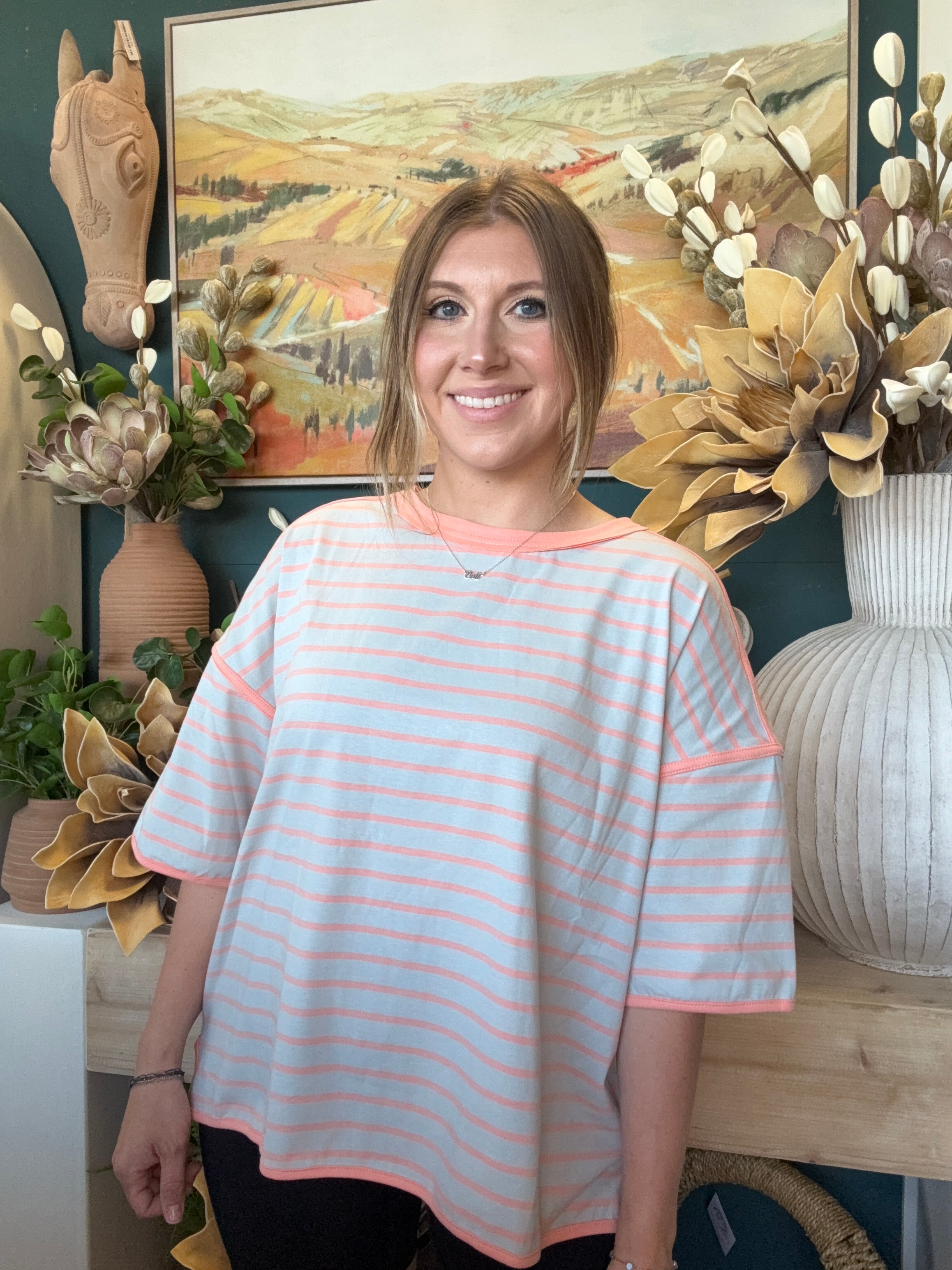 women's blue and apricot striped oversized knit top with relaxed fit and exposed seam details