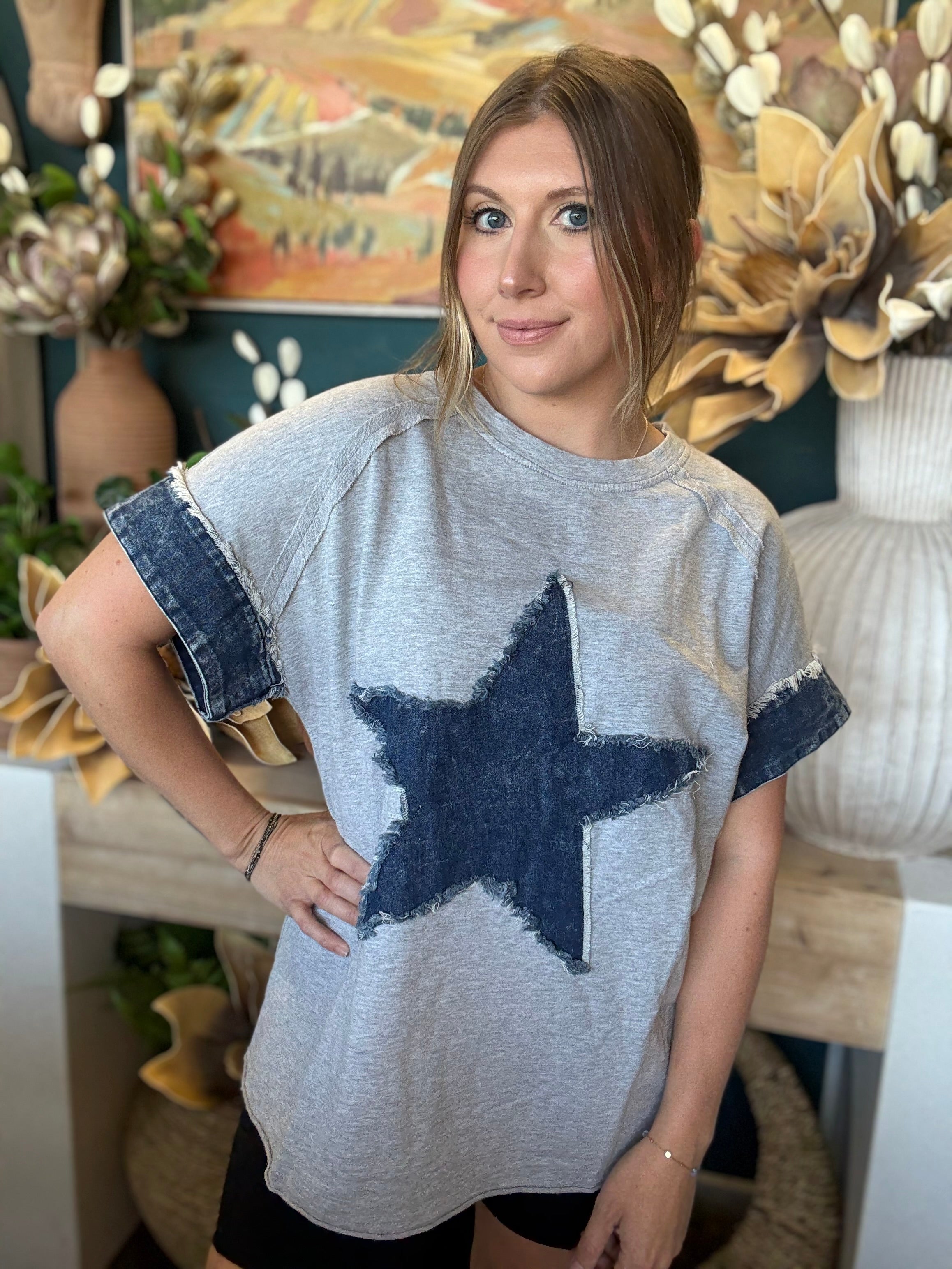 women's oversized gray top with distressed denim star applique and rolled denim sleeves