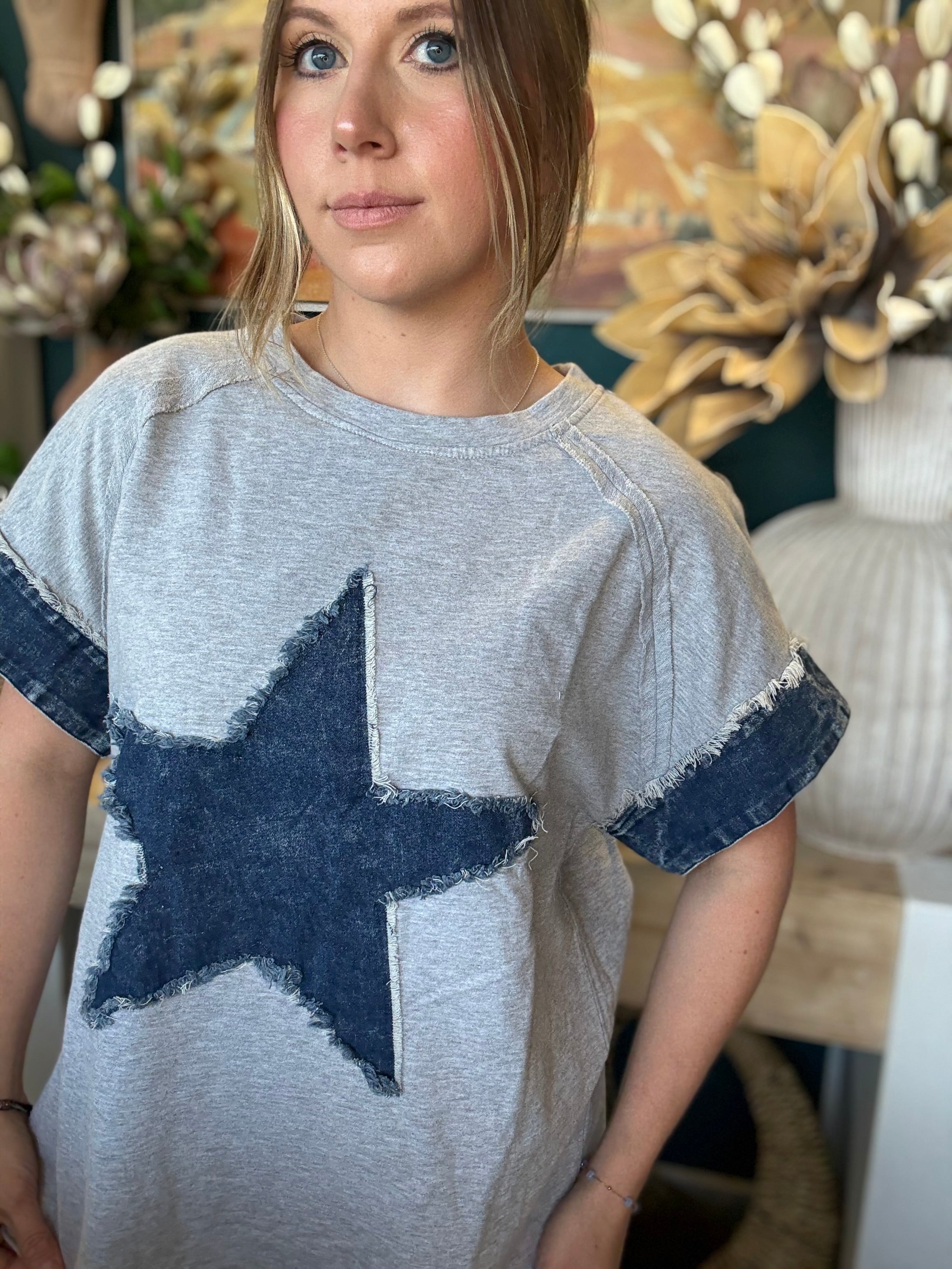women's oversized gray top with distressed denim star applique and rolled denim sleeves