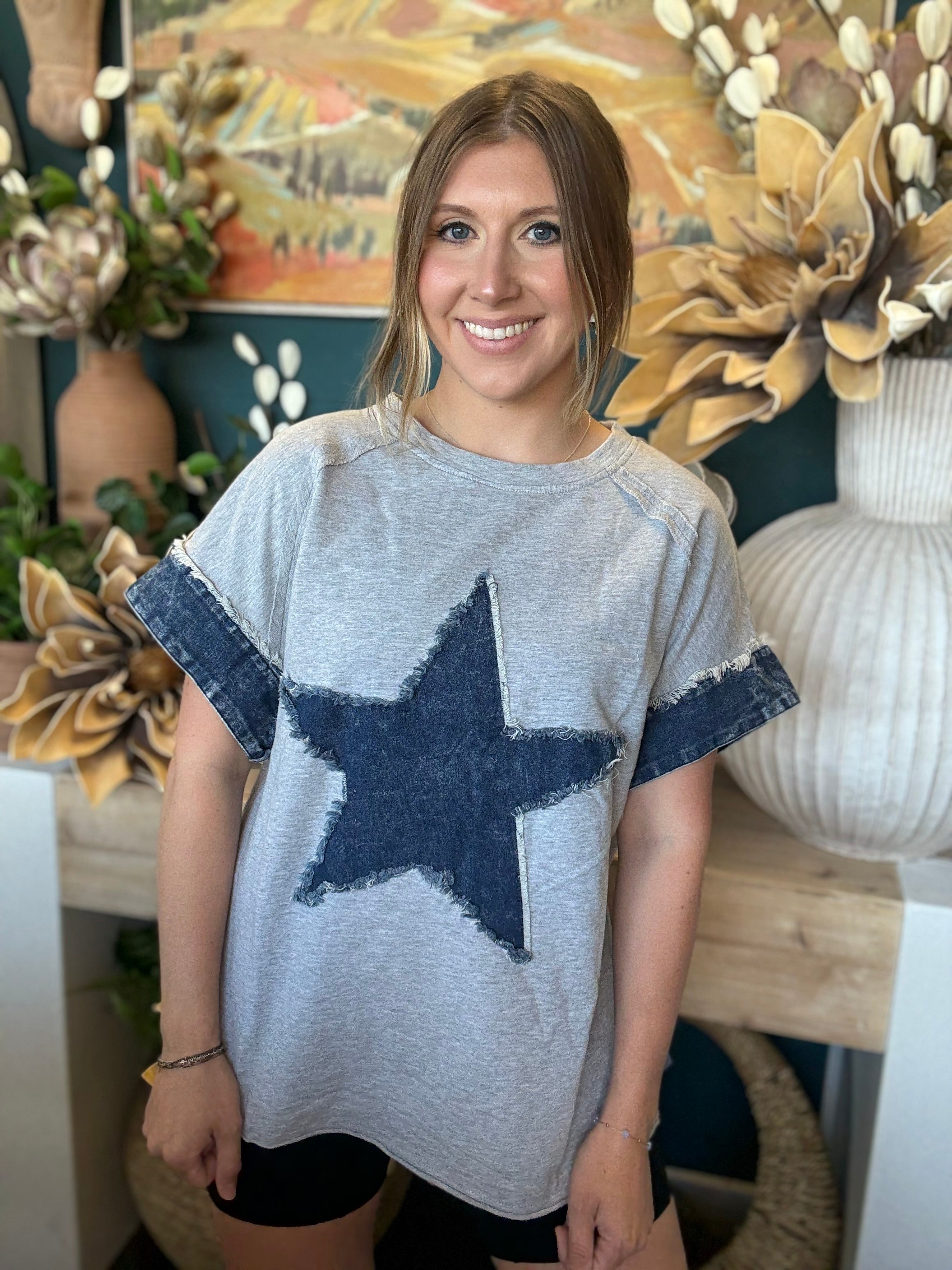 women's oversized gray top with distressed denim star applique and rolled denim sleeves
