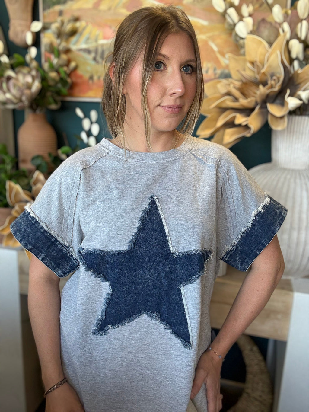 women's oversized gray top with distressed denim star applique and rolled denim sleeves