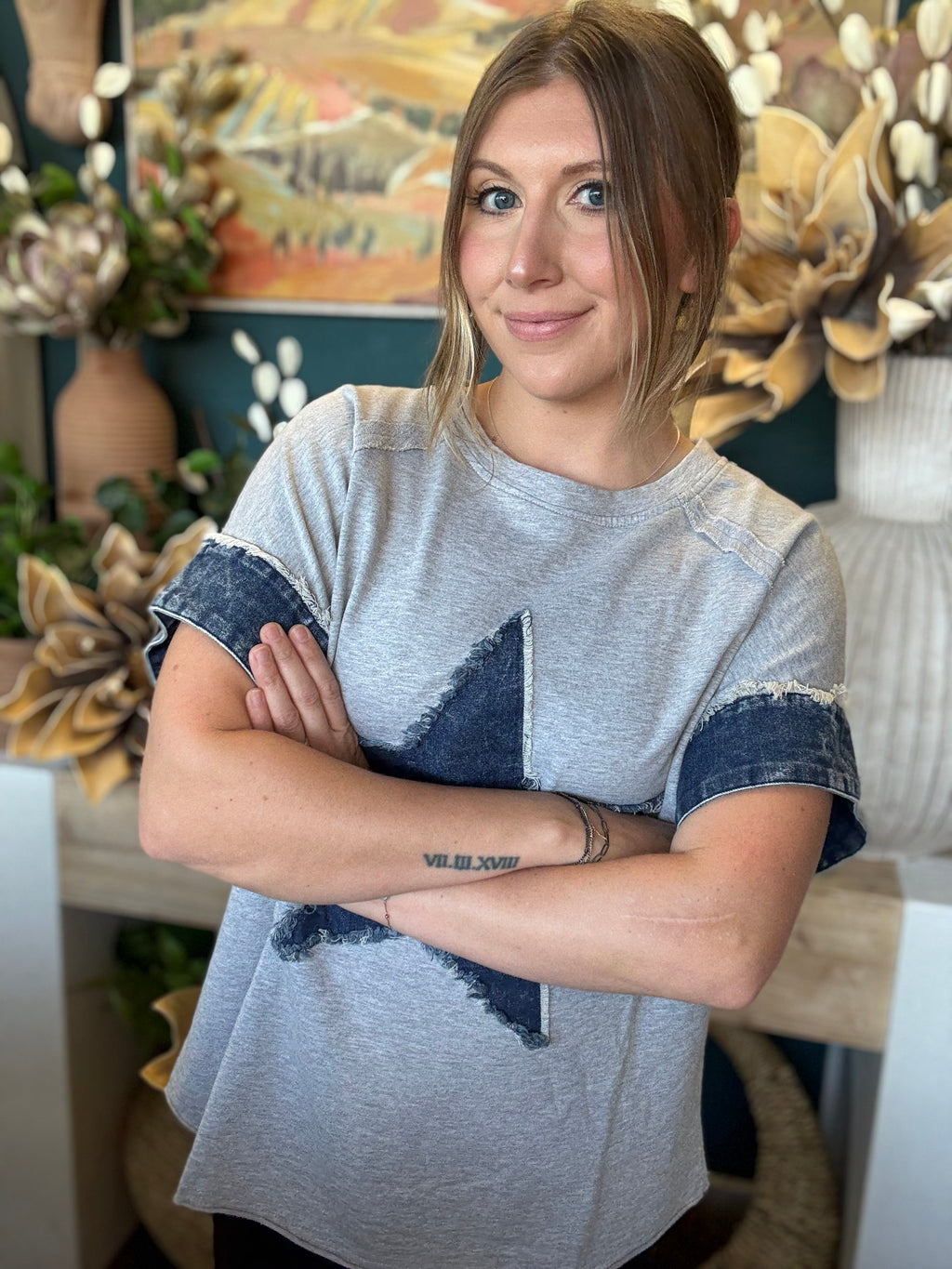 women's oversized gray top with distressed denim star applique and rolled denim sleeves